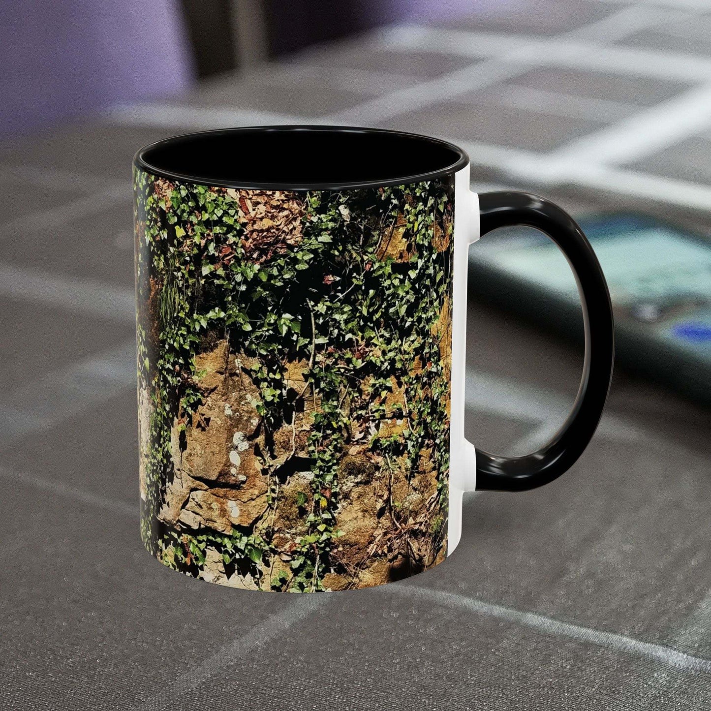 Overgrown Rocks Adventure Mug with nature-inspired design on table.