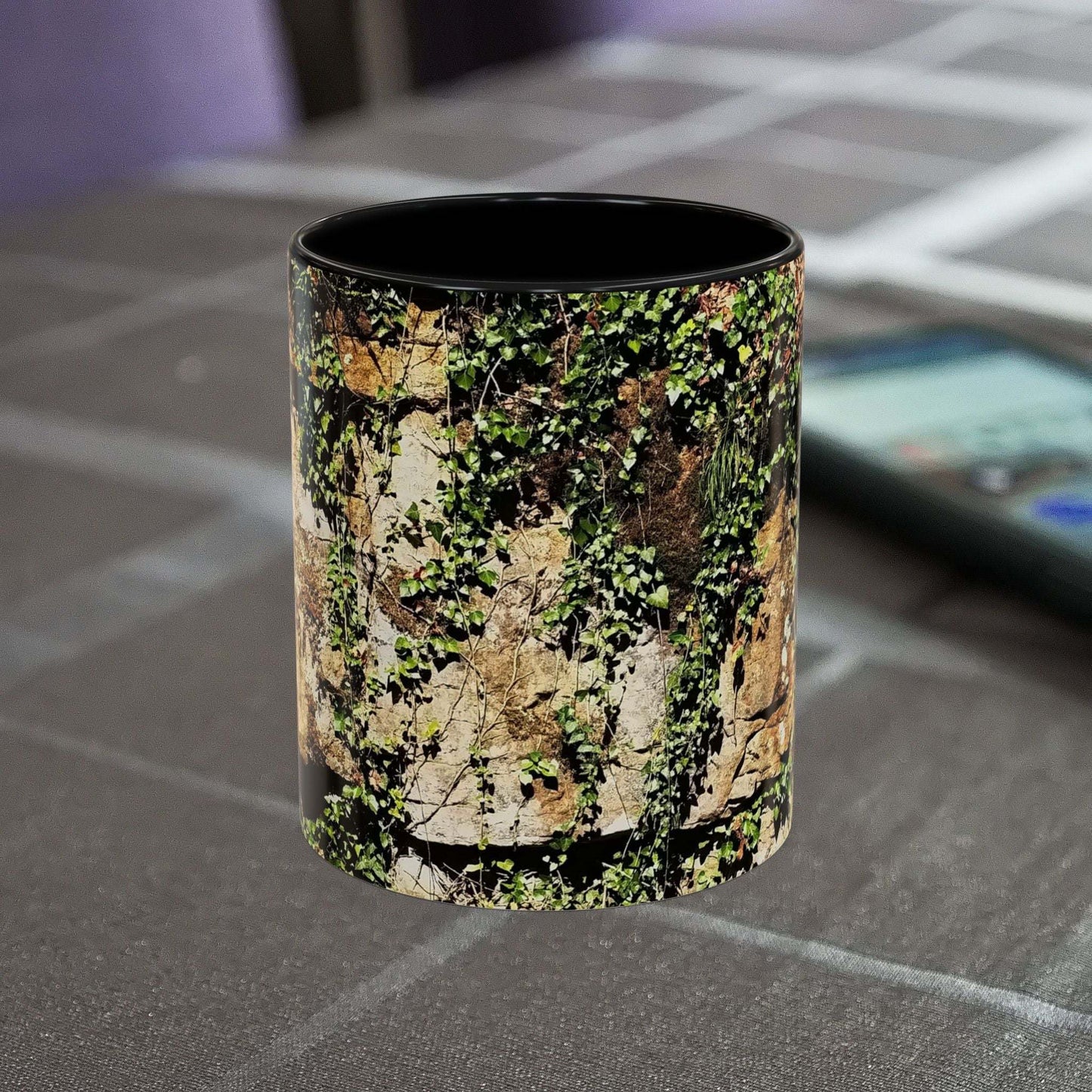 Overgrown rocks adventure coffee mug on table.