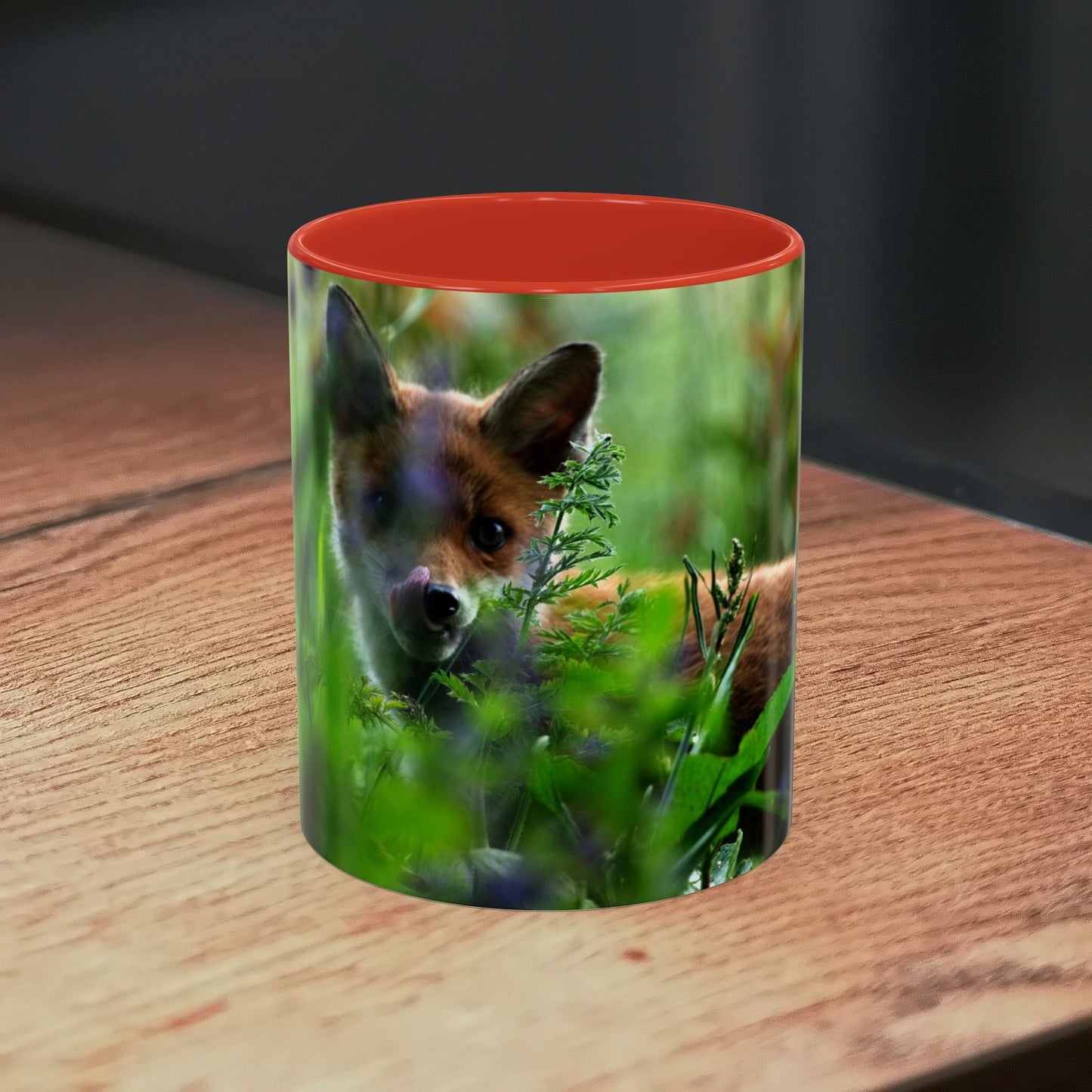 Fox-inspired accent coffee mug with wildlife design on wooden table.
