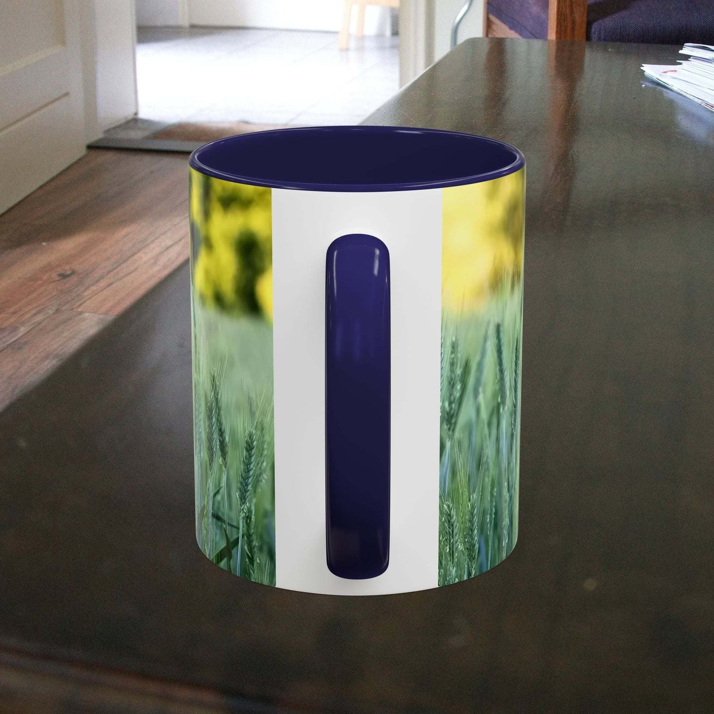 Wheat field design coffee mug on a wooden table.