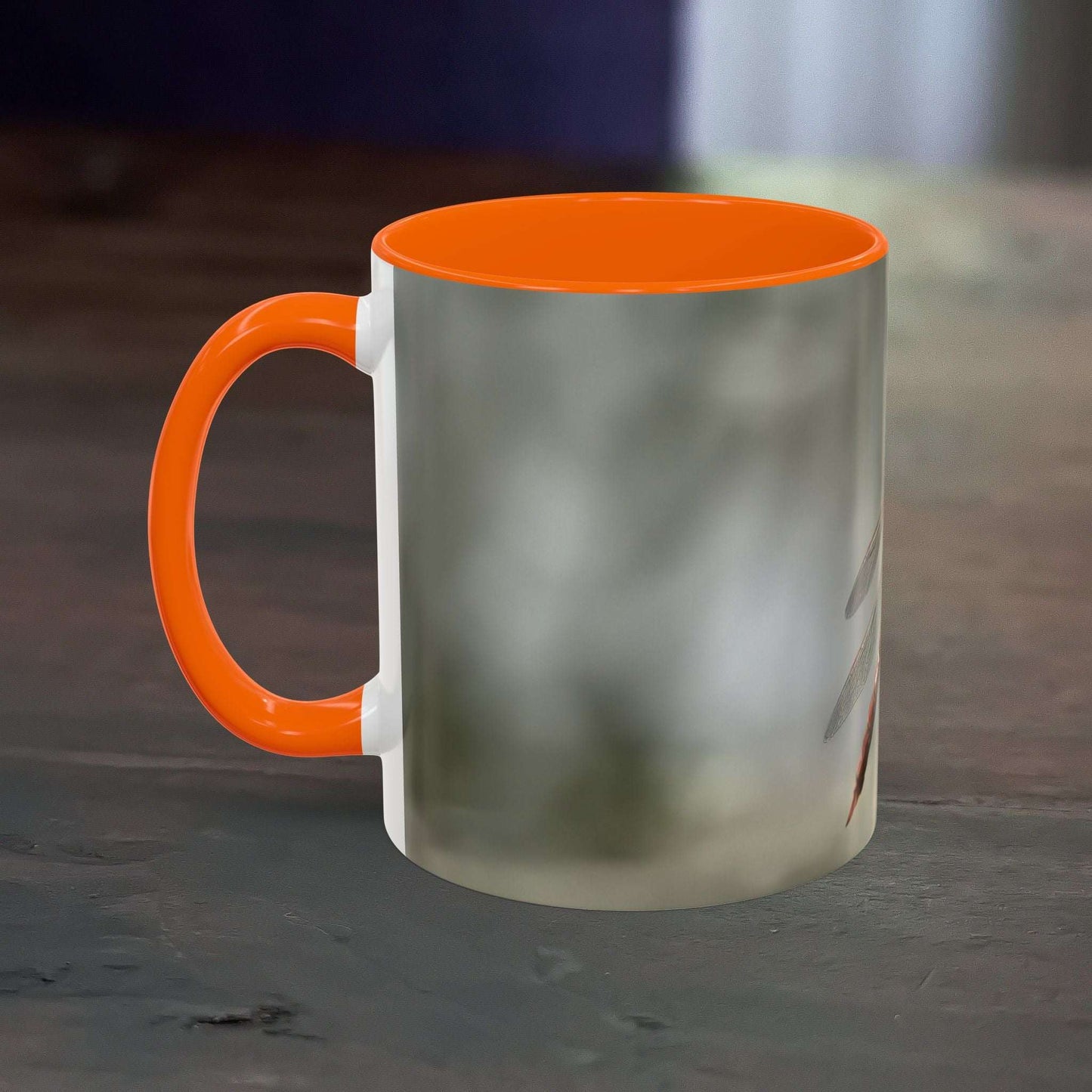 Pretty dragonfly accent coffee mug with vibrant orange handle and interior, crafted from high-quality ceramic.