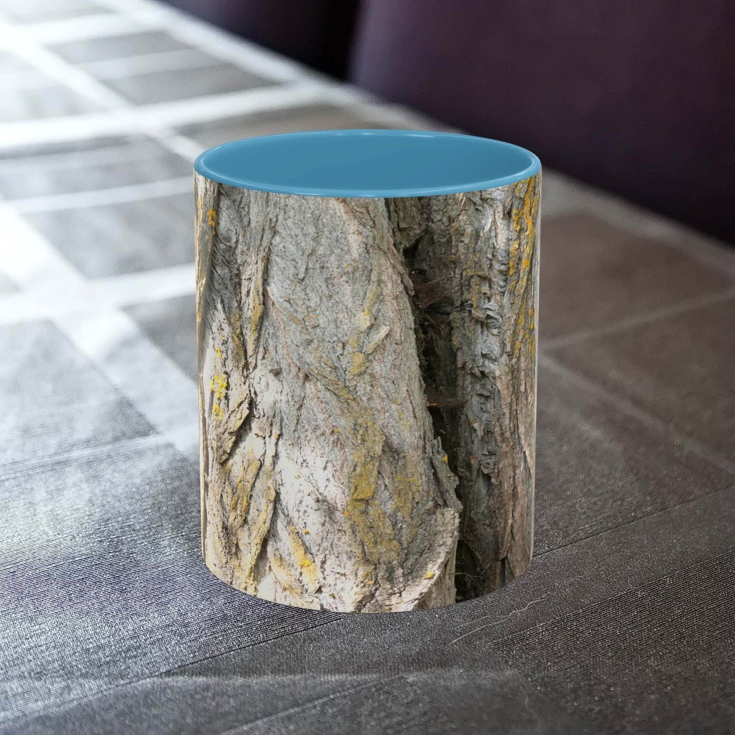 Coffee mug with tree trunk design on a table, ideal for nature lovers.