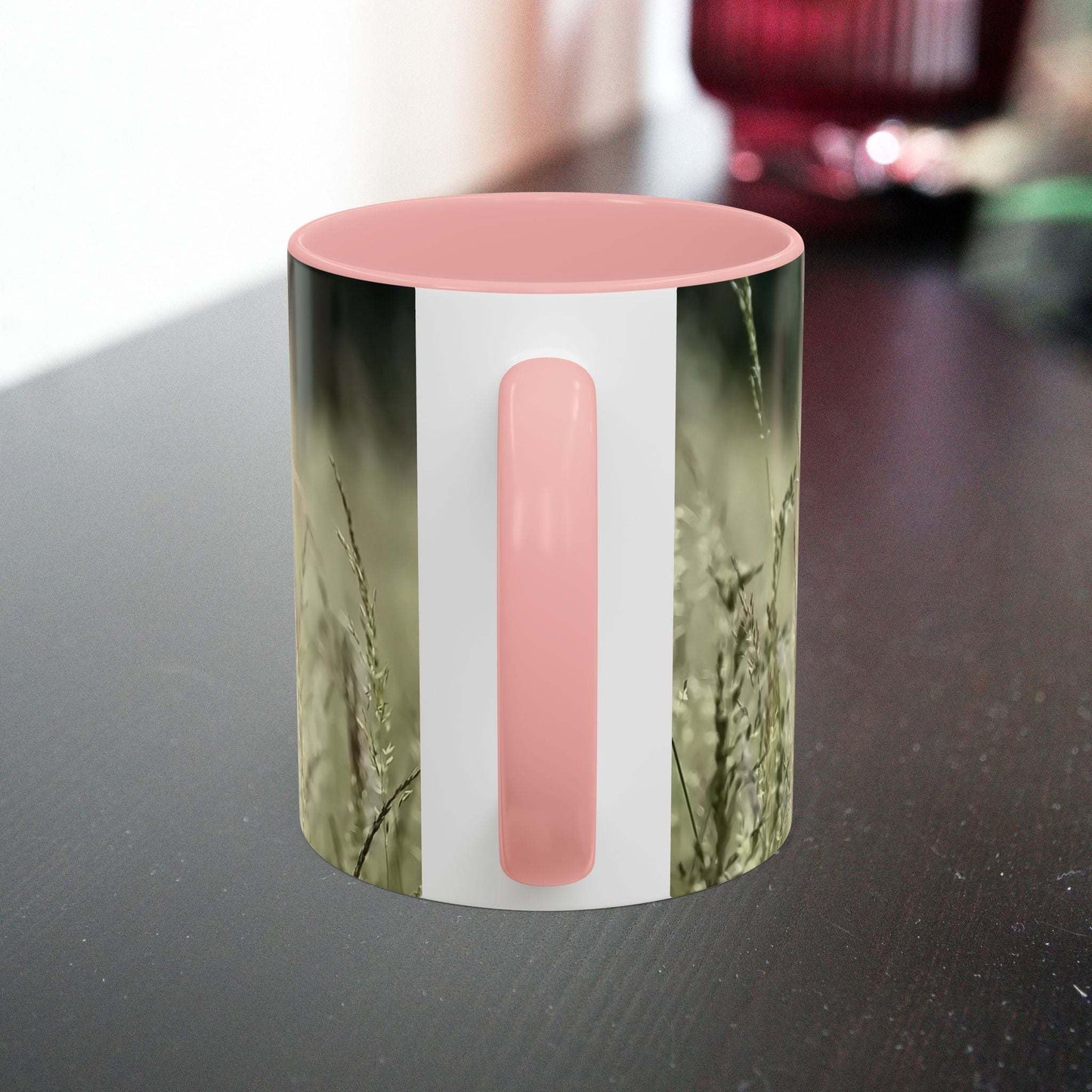 Ceramic mug with flowering grass design and pink interior.