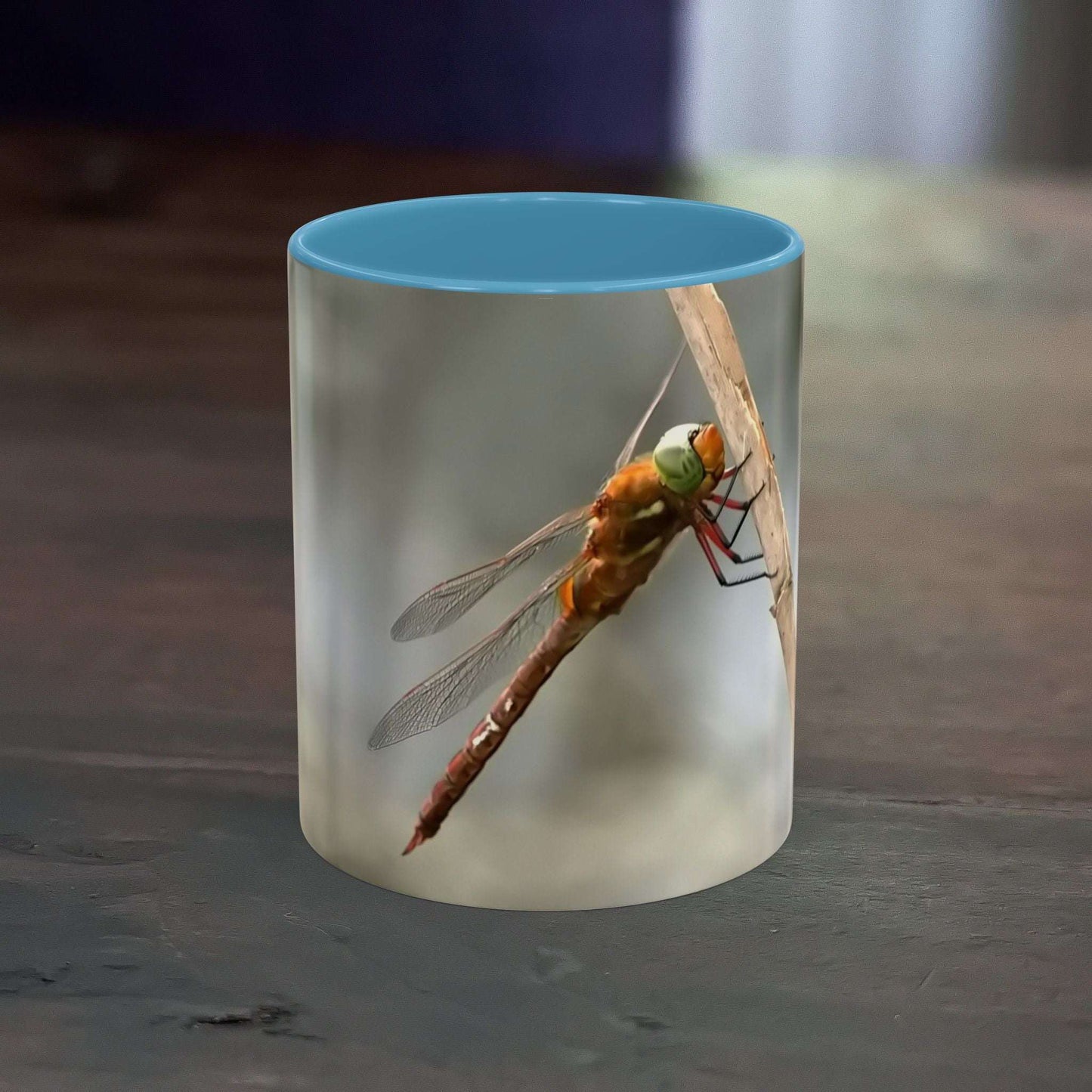 Pretty dragonfly accent coffee mug with vibrant blue interior and high-quality ceramic design.