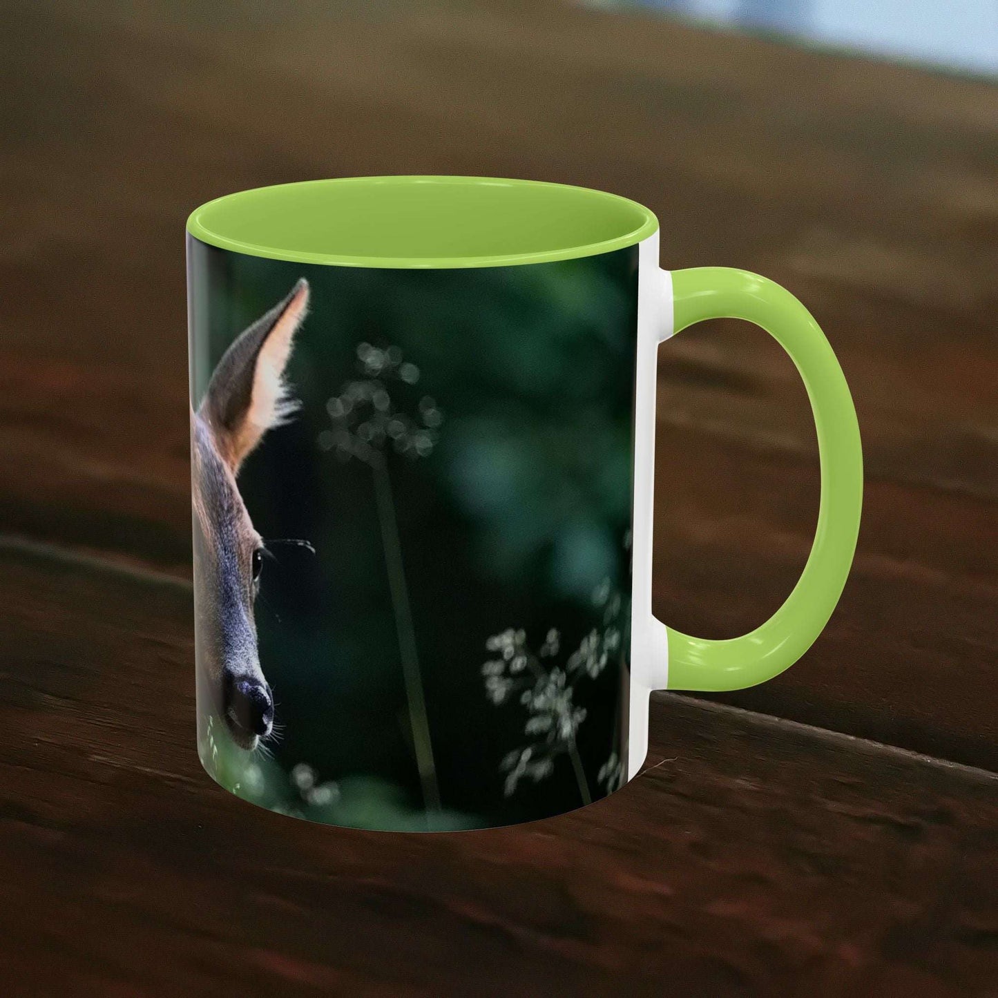 Mug with nature-inspired deer print and floral elements, ceramic, green interior.