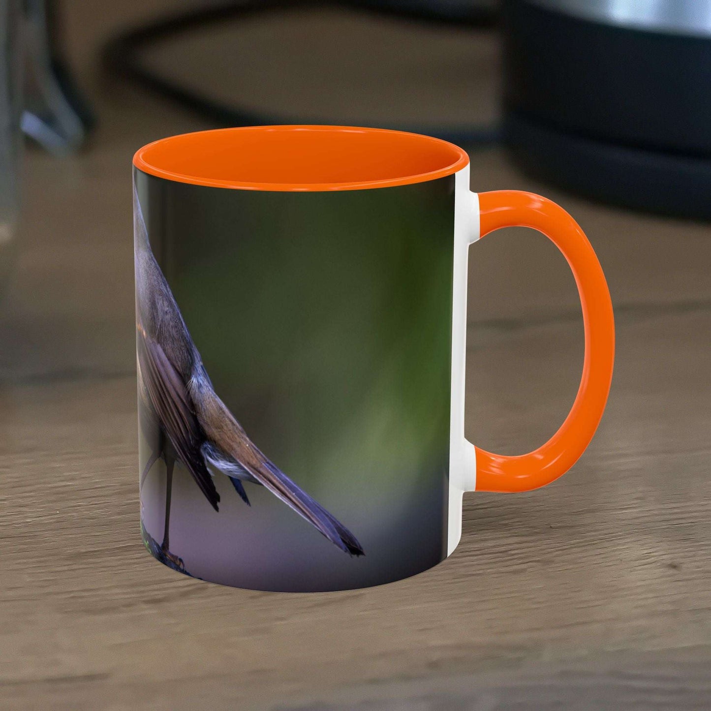 White ceramic 11oz mug with robin illustration, orange interior, perfect for nature lovers.