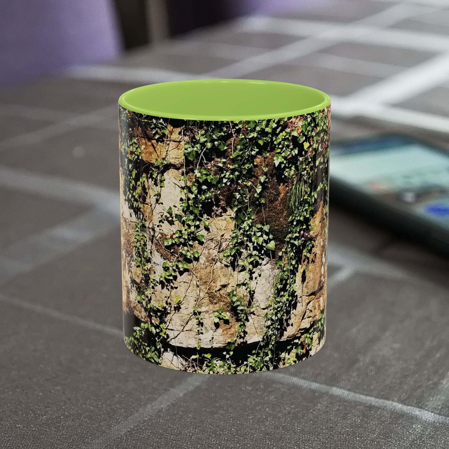 Overgrown Rocks Adventure Mug with nature-inspired design on table.