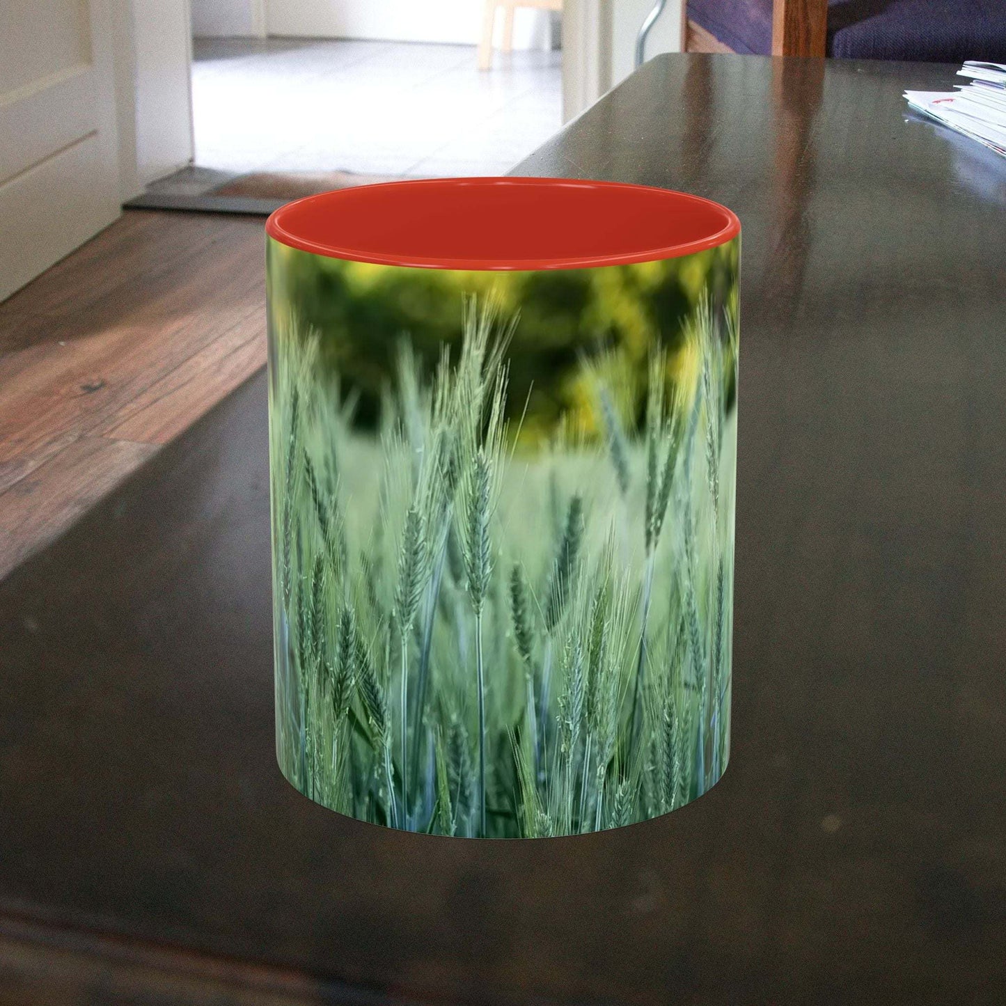 Wheat field design coffee mug on table, nature-inspired.