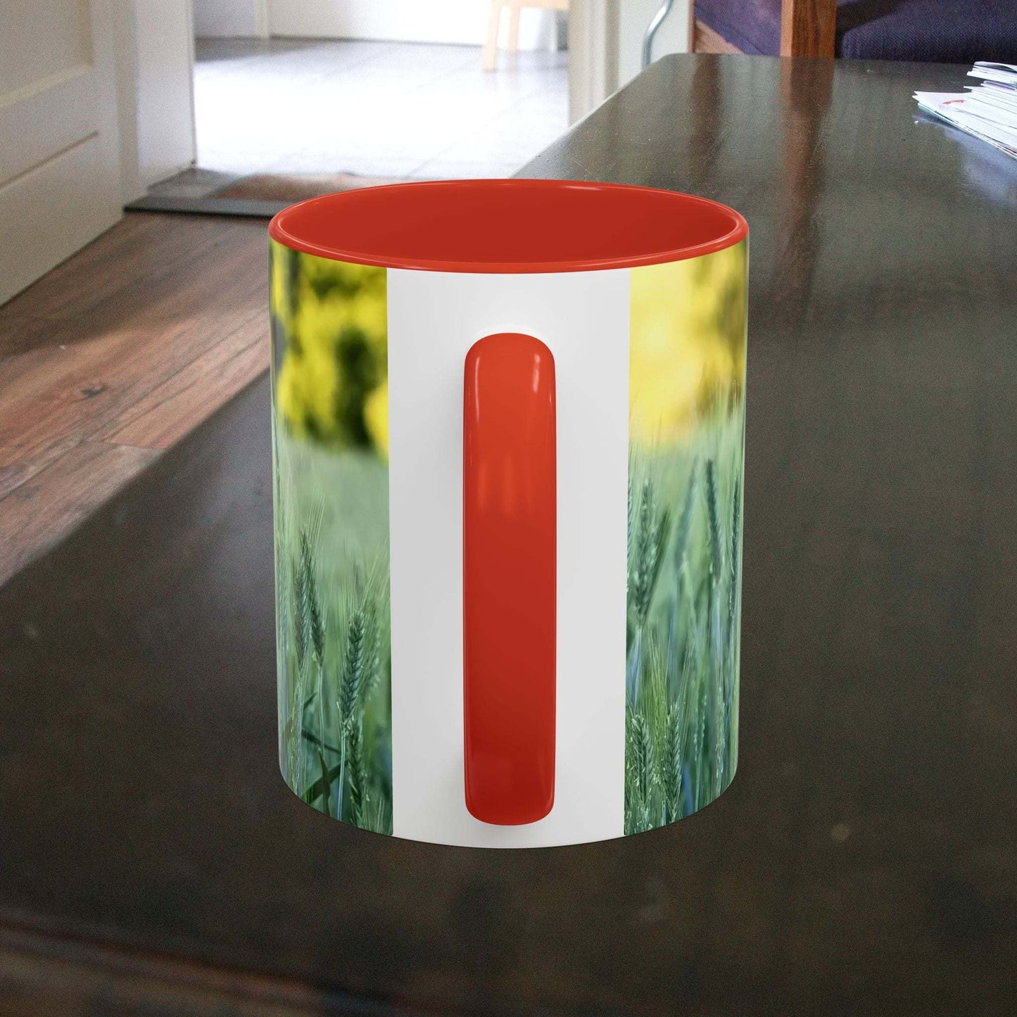 Wheat field design coffee mug on a table with vibrant colors.