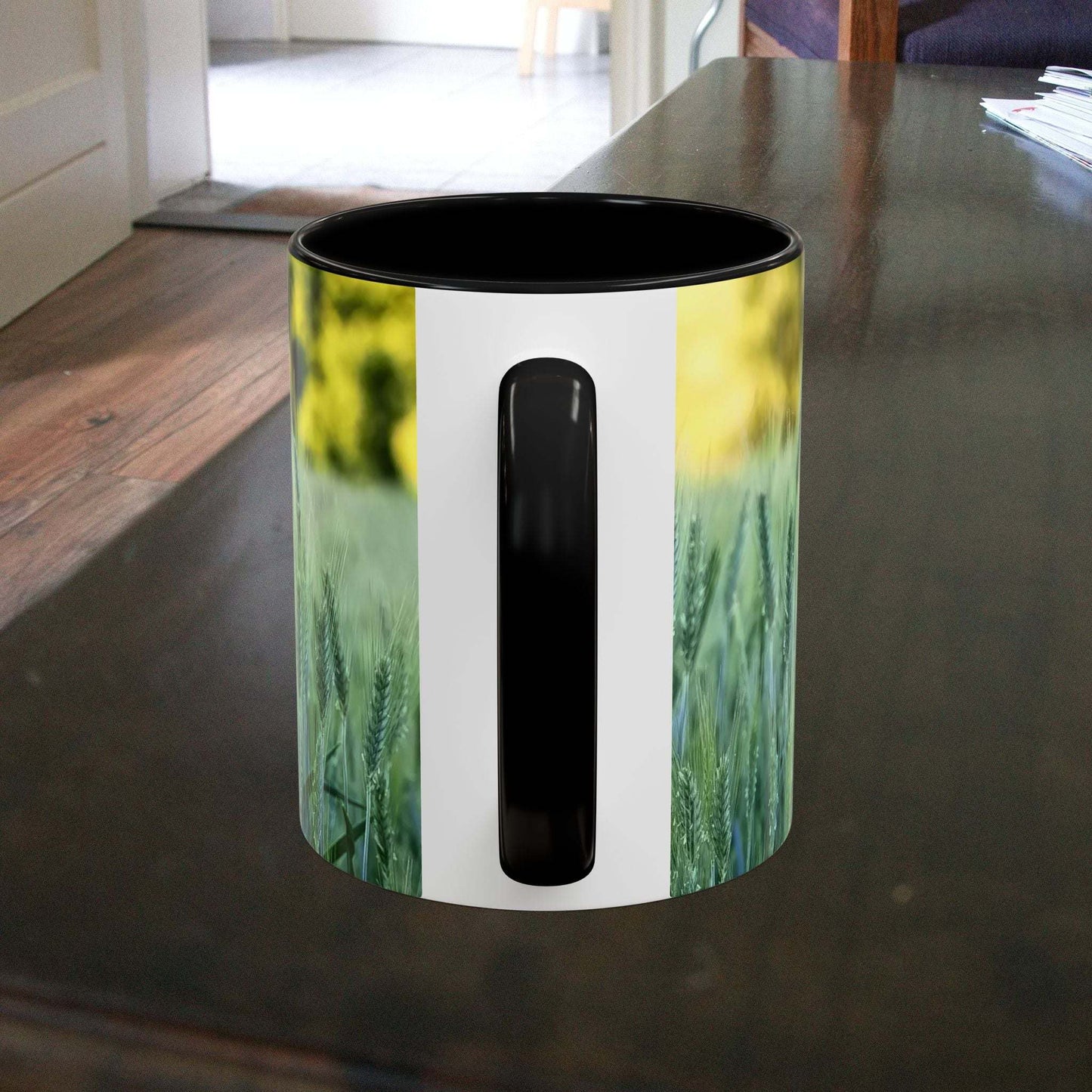 Wheat field design coffee mug on wooden surface.