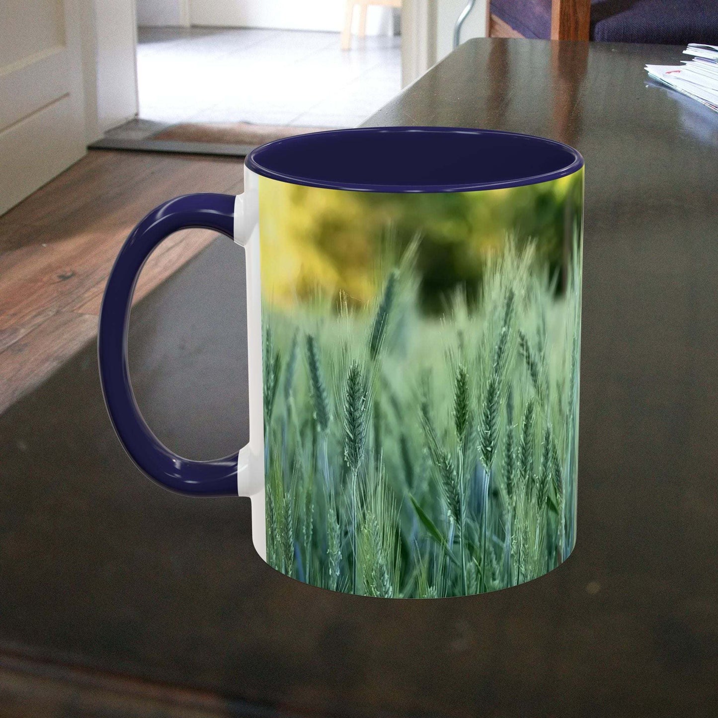 Wheat field design coffee mug on table.