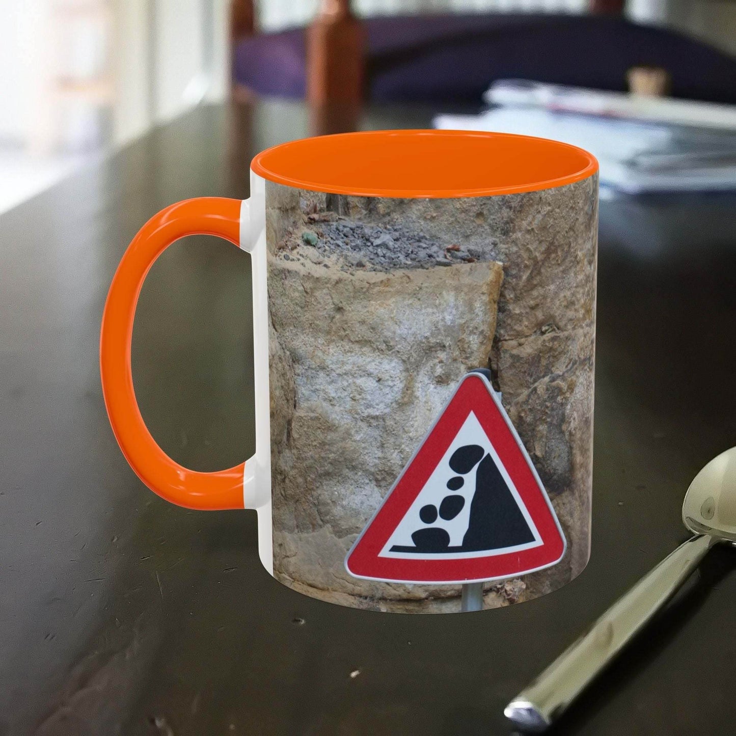 Rocky Mug with falling rocks design, perfect for mountain lovers.