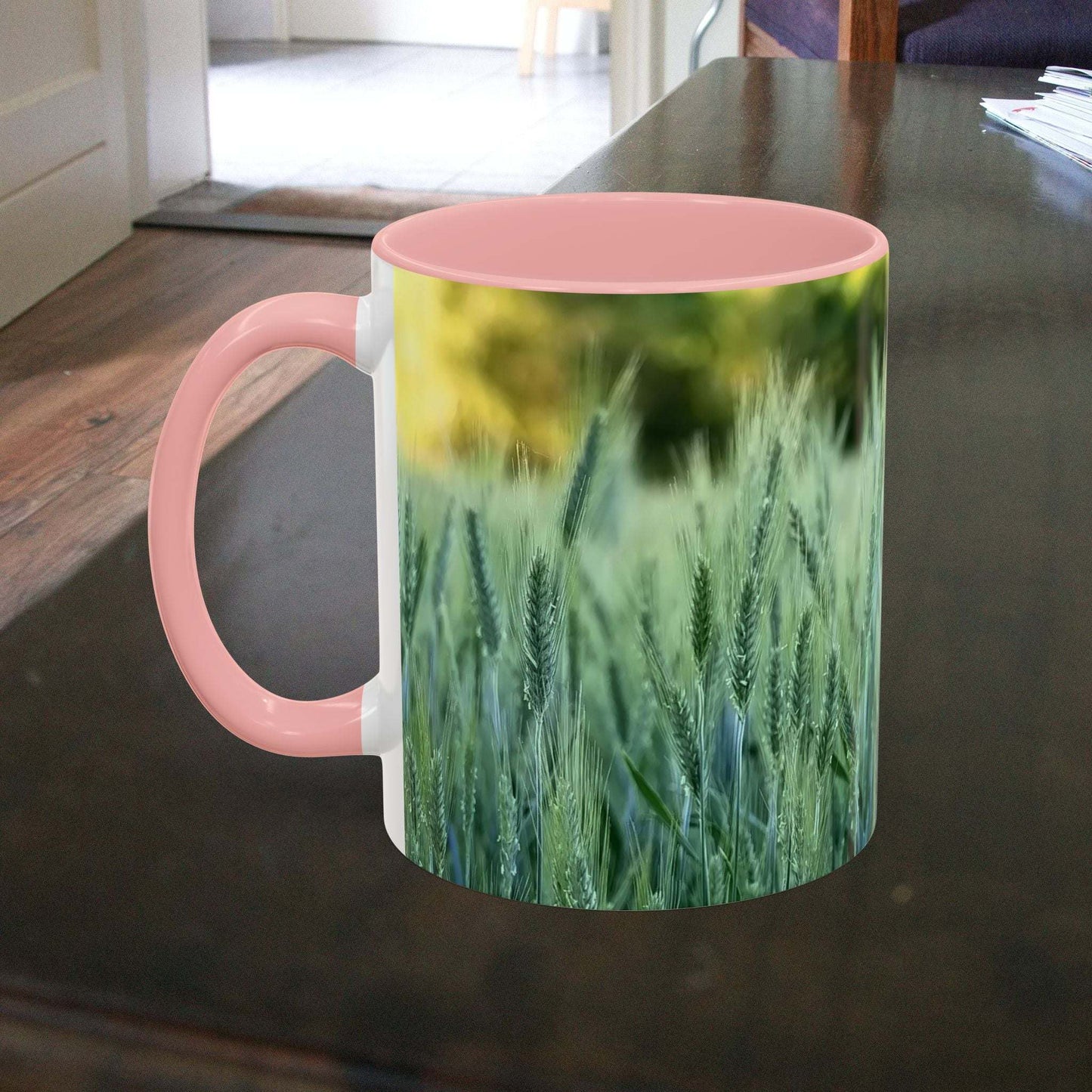 Wheat field design coffee mug with pink handle.