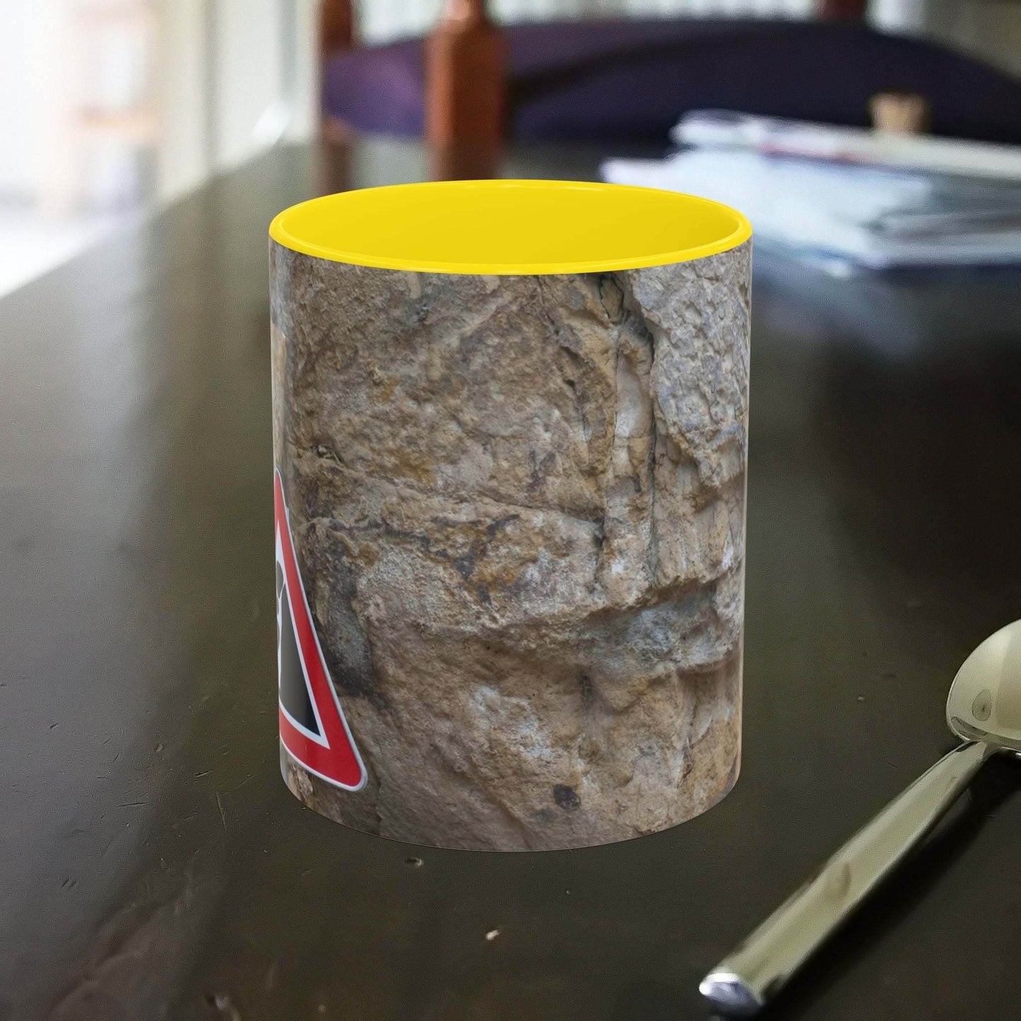 Rocky Mug with falling rocks design, perfect for mountain lovers.