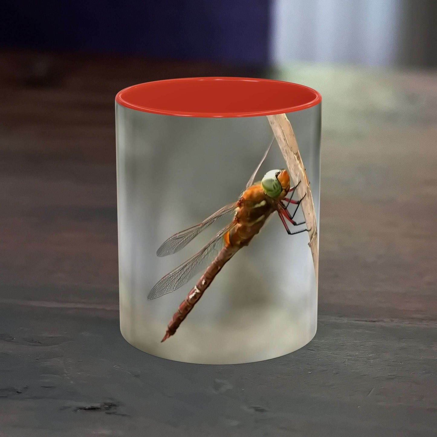 White ceramic mug with a colorful dragonfly design and red interior, 11oz capacity.