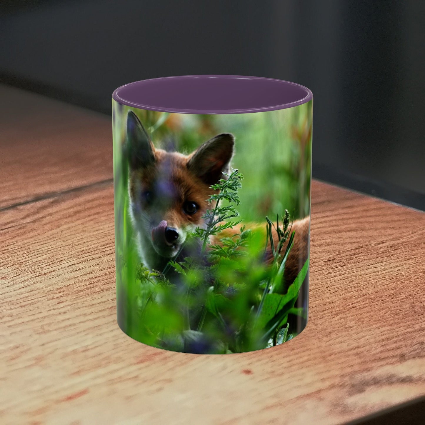 Fox-themed accent coffee mug with wildlife design on wooden table.