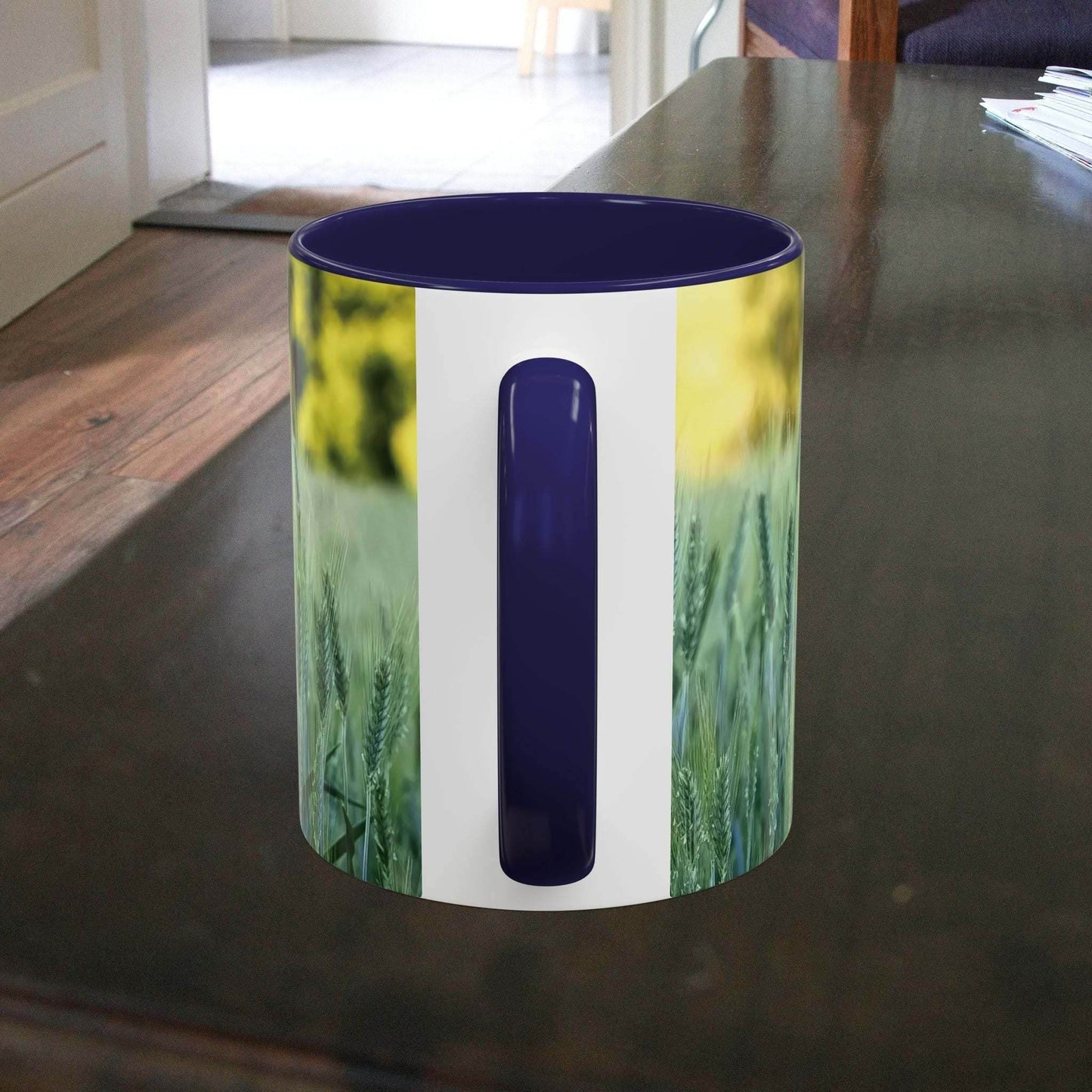 Wheat field design coffee mug on wooden table.