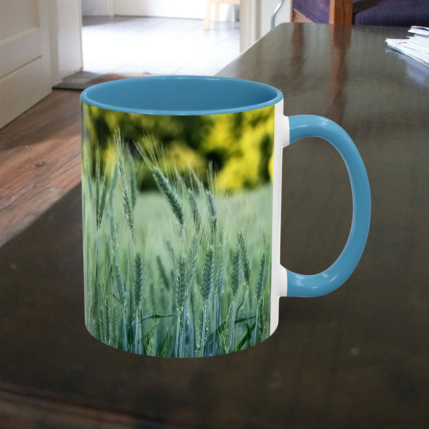 Wheat field design coffee mug on table, nature-inspired gift.
