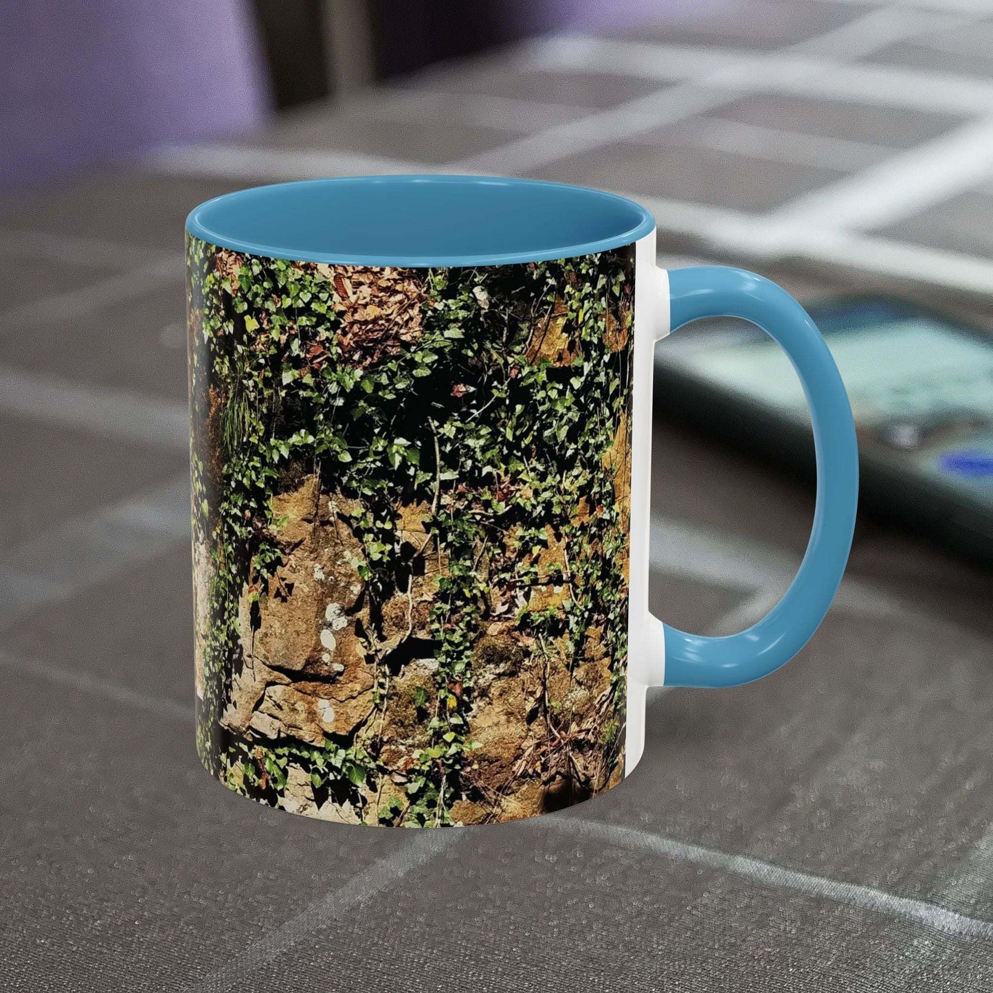 Overgrown Rocks Adventure Mug with nature-inspired design on table.