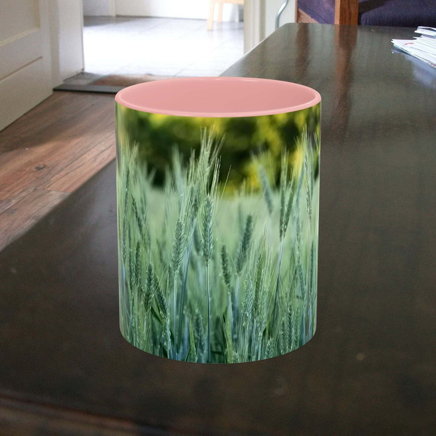 Wheat field design coffee mug on table.