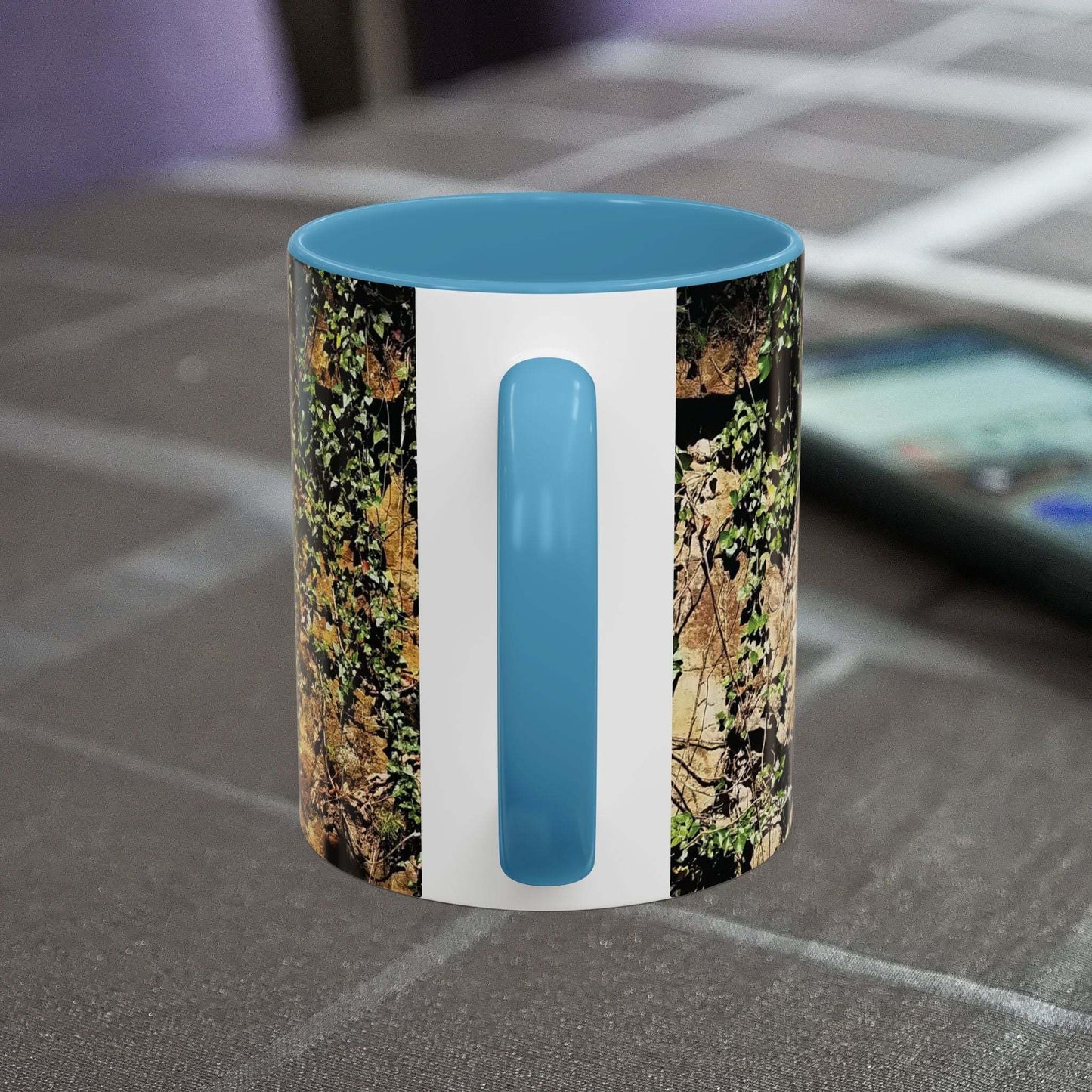 Overgrown Rocks Adventure Mug with outdoor-inspired design on table.
