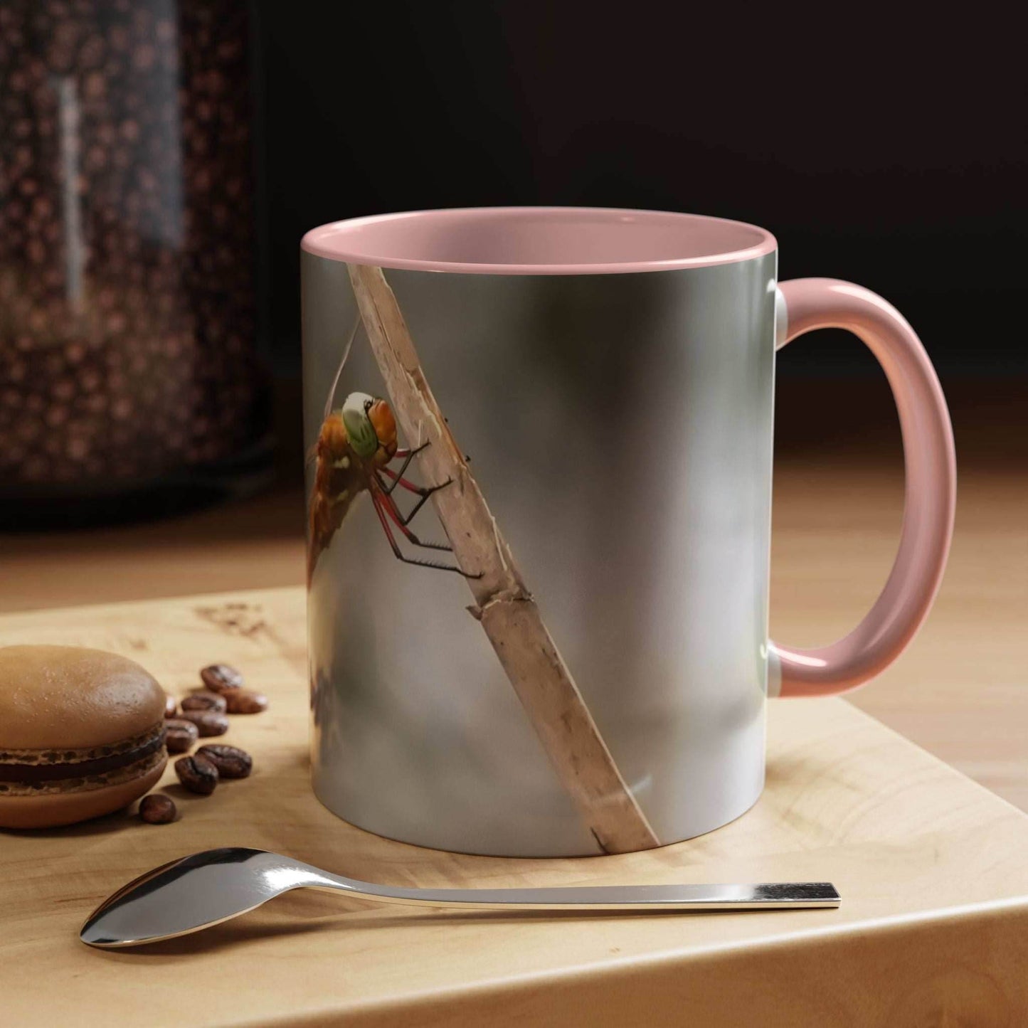 White ceramic mug with dragonfly design and pink handle, 11oz capacity.