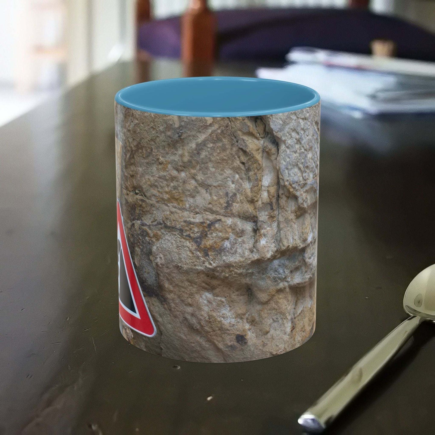 Rocky Mug with falling rocks design, ideal for mountain lovers.