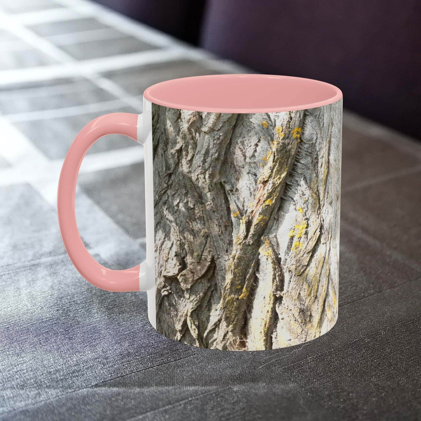 Rustic coffee mug with tree trunk design and pink interior.