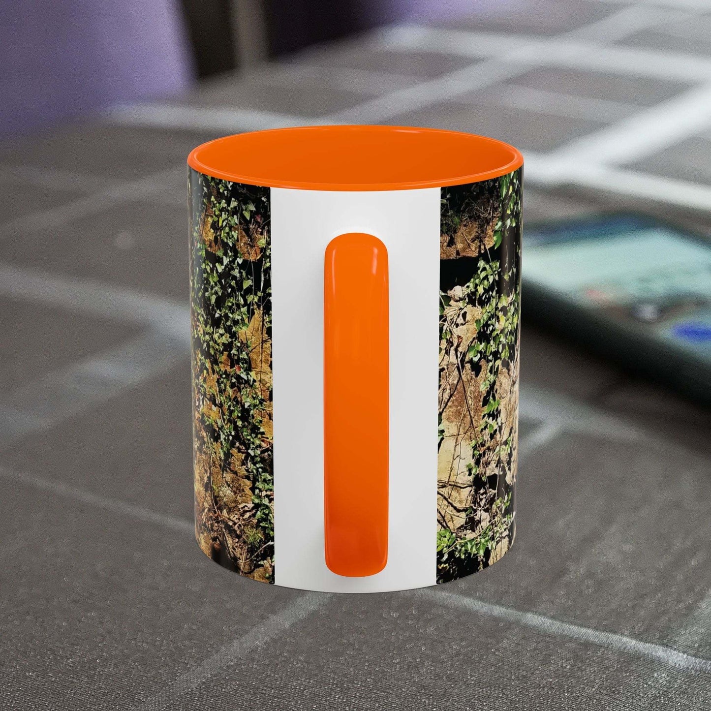 Overgrown Rocks Adventure Coffee Mug with outdoor design on table.