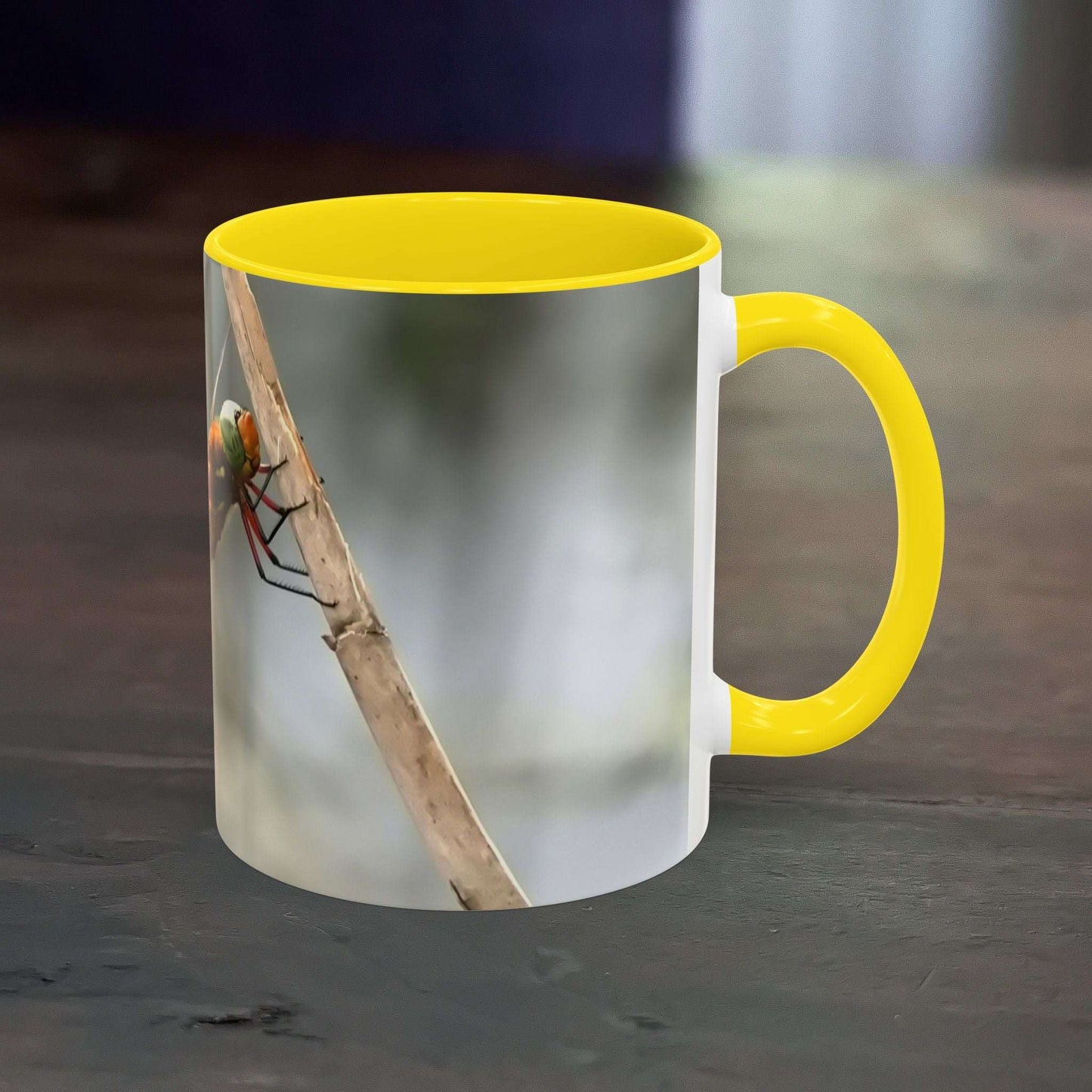 Mug with dragonfly design and yellow accent handle and interior.