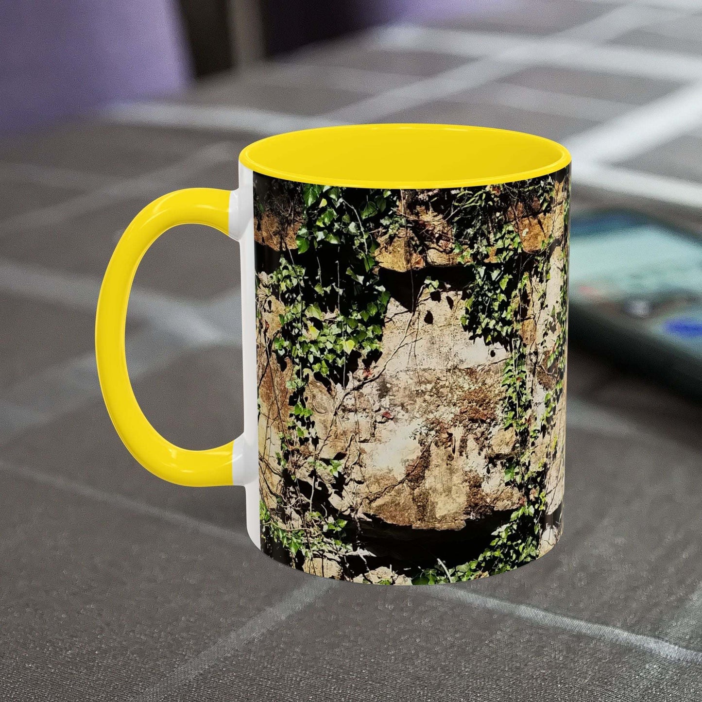 Overgrown Rocks Adventure coffee mug with nature design on table.