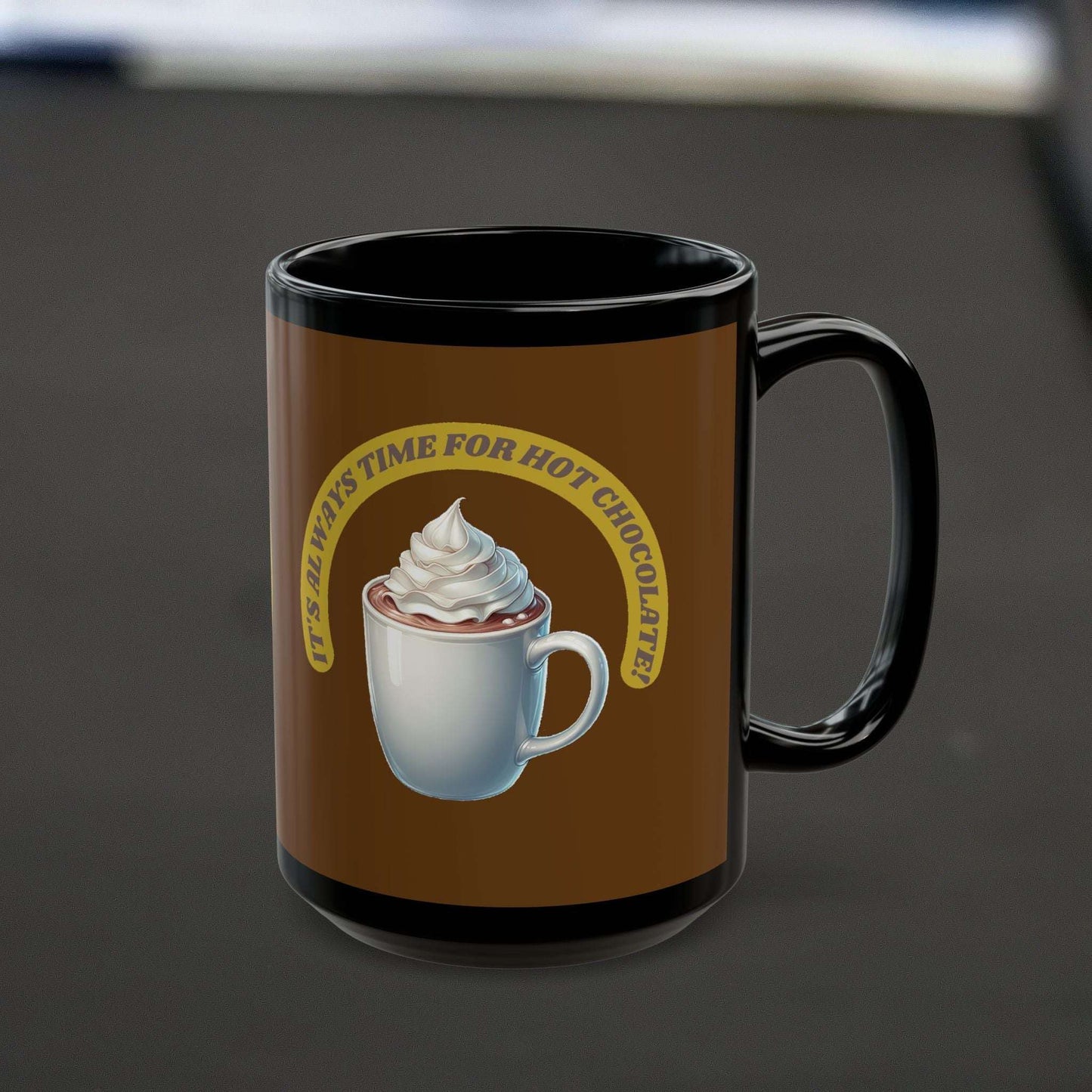 Black ceramic mug with "It's always time for hot chocolate" design, ideal for winter beverages.
