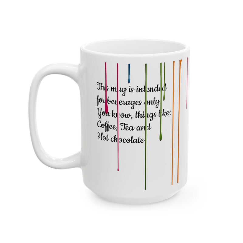 Large 15oz Paint Drips Mug, Ceramic Coffee Cup showing its crisp rainbow print colors on a rustic wooden table.