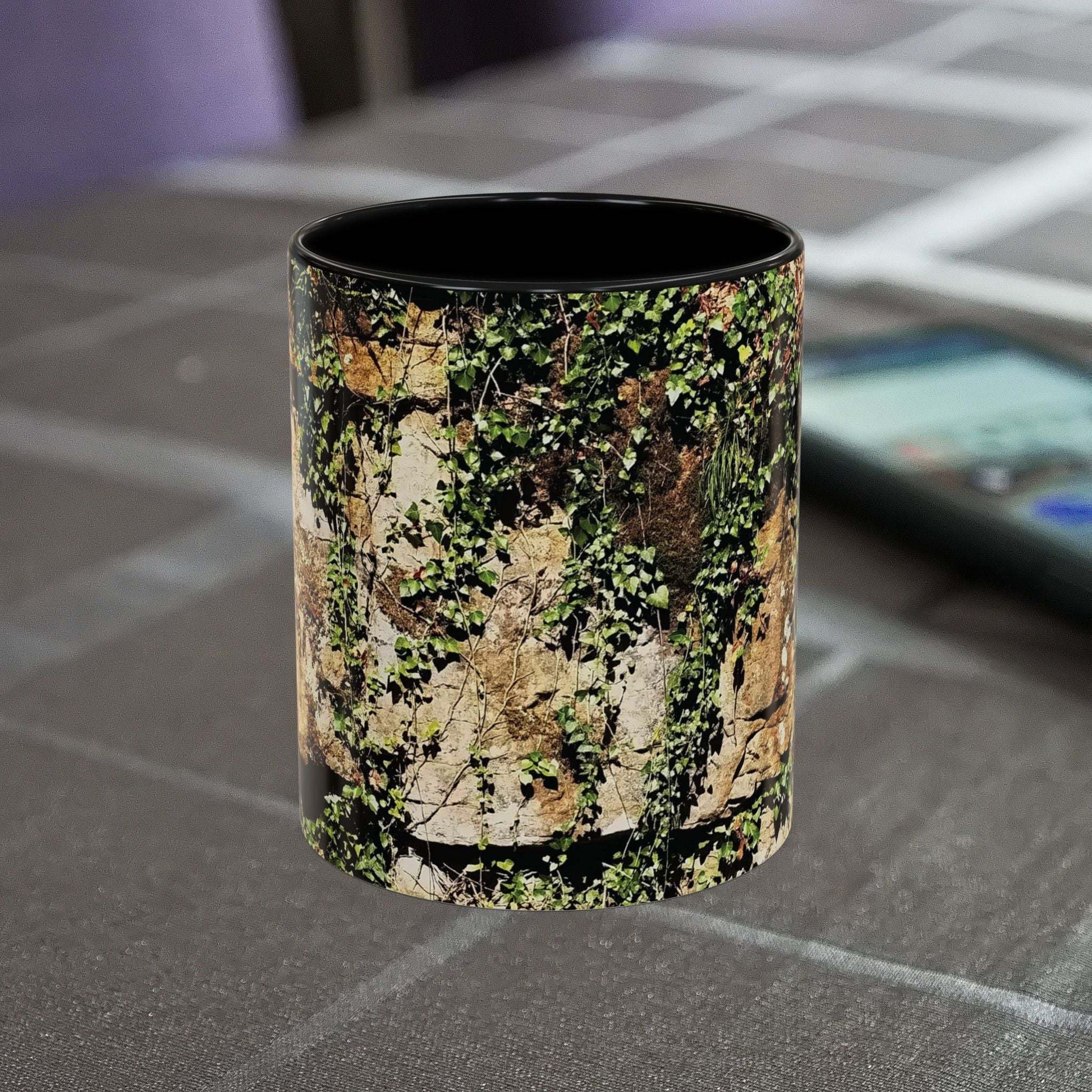 Overgrown Rocks Adventure Mug with nature-inspired design on a table.
