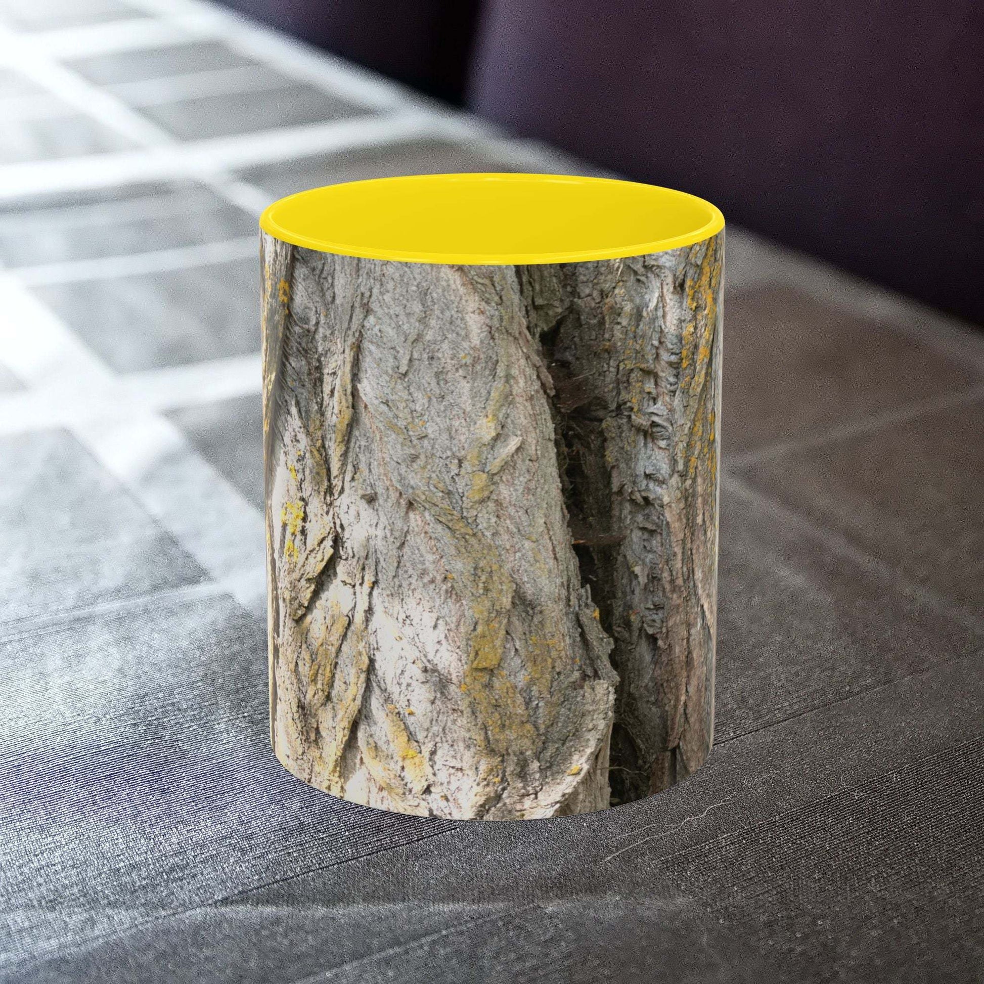 Coffee mug with a tree trunk design on a table.