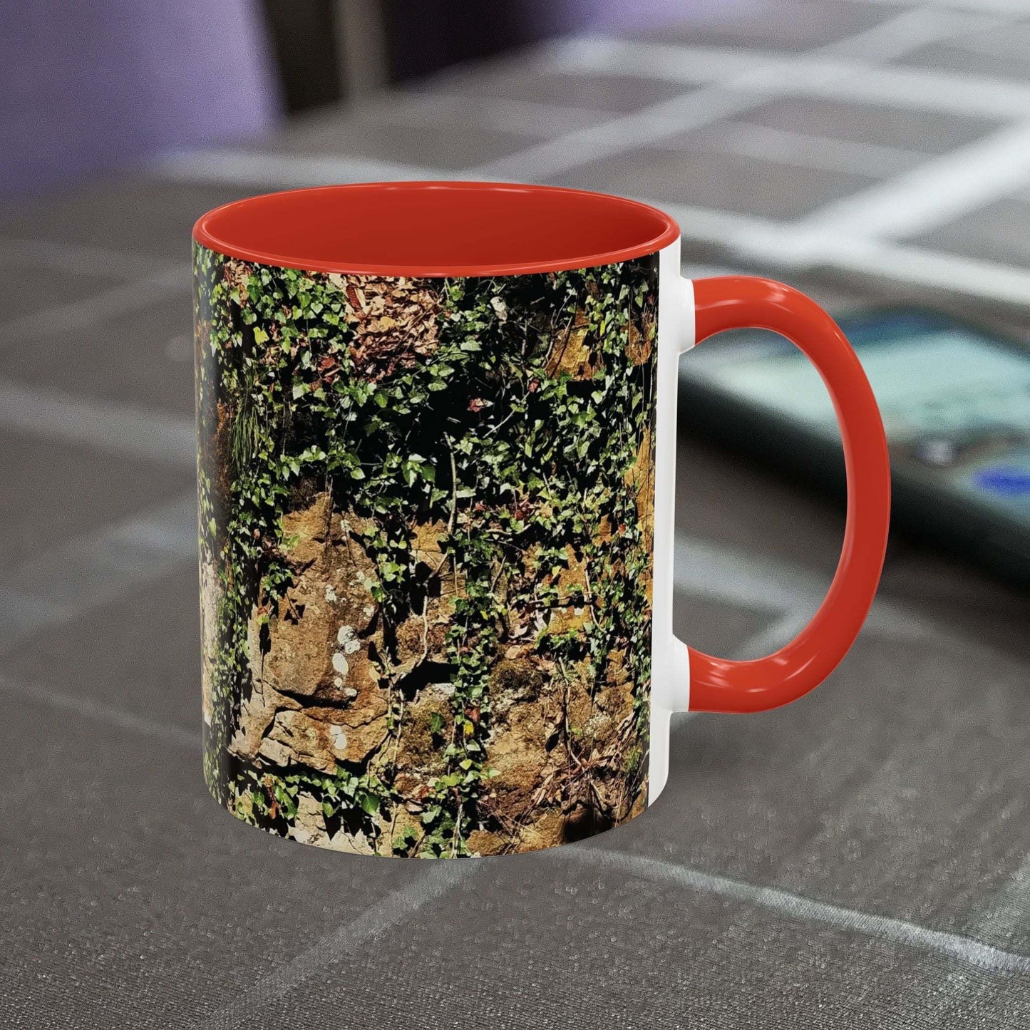 Overgrown rocks adventure mug with nature design on table.