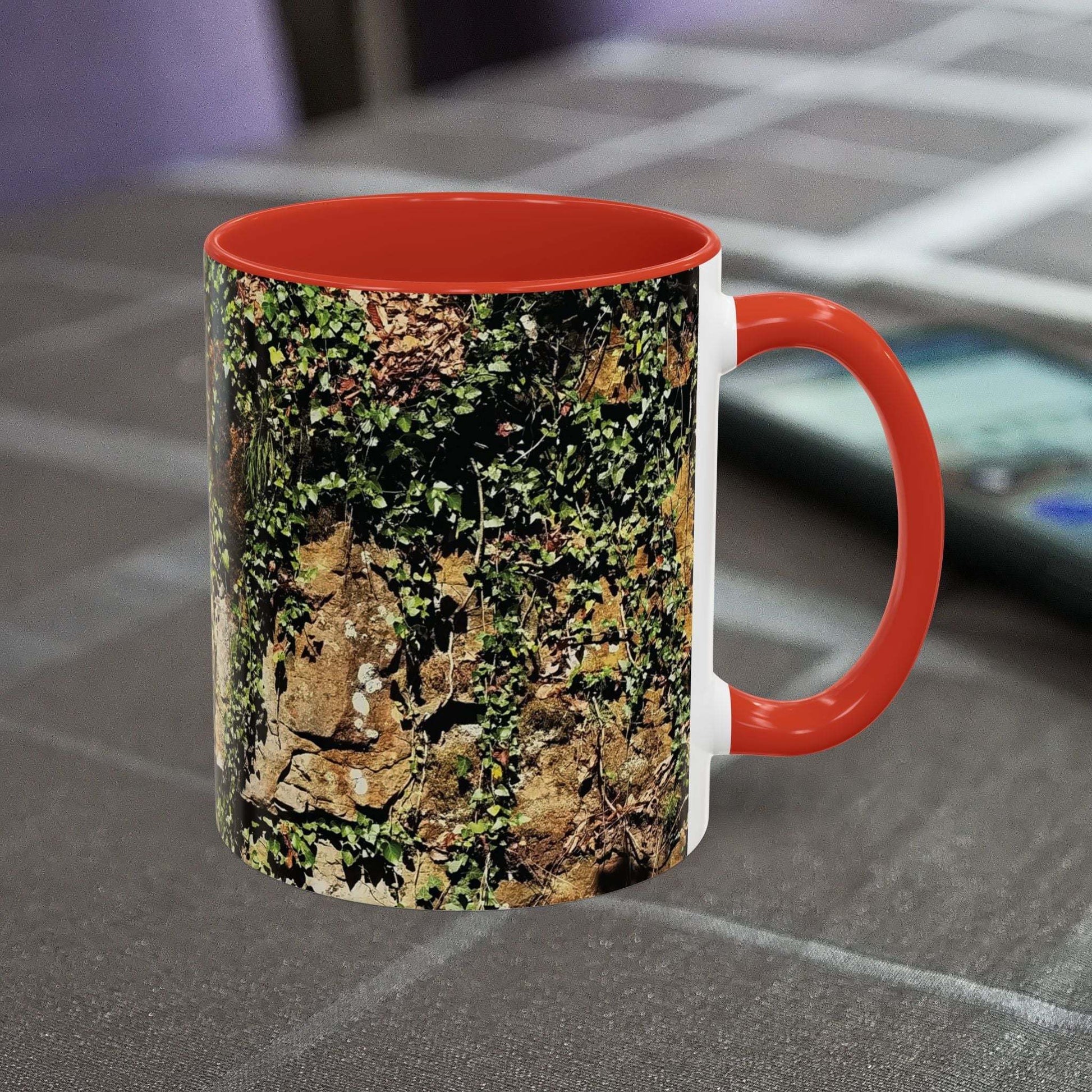 Overgrown rocks adventure mug with nature design on table.