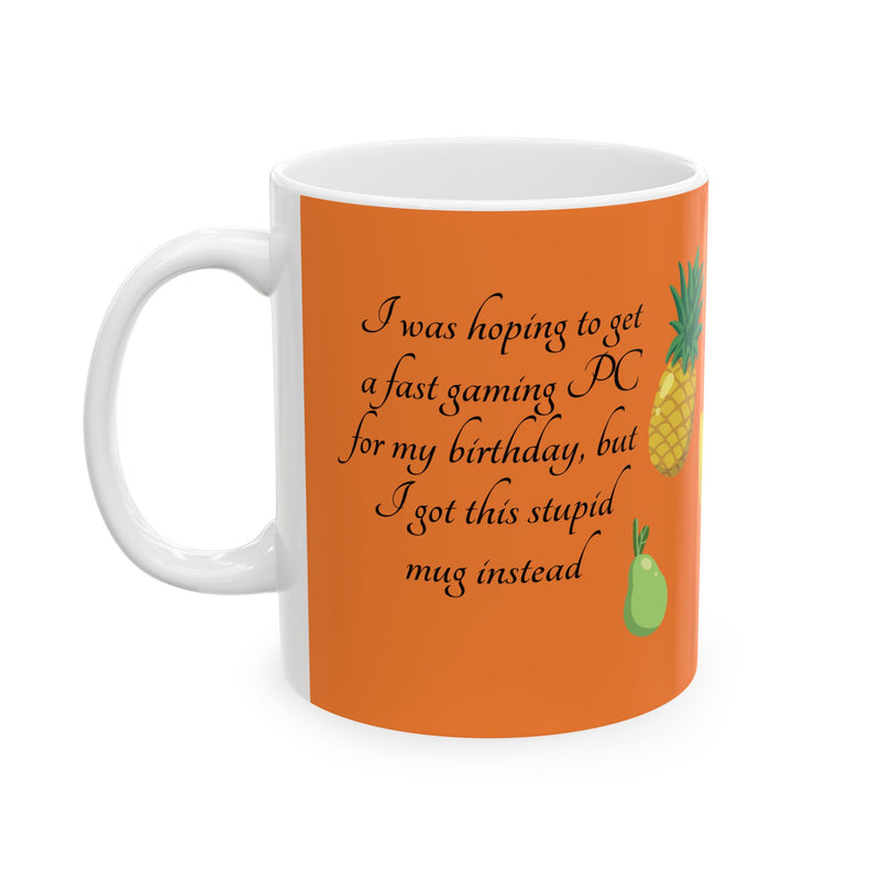 Vibrant 11oz orange Coffee Mug — 'I got a stupid mug for my birthday' with fruit icons on a modern kitchen counter.