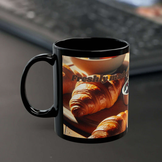 Black ceramic coffee mug with glossy finish and "Freshly Made" design, ideal for coffee lovers; available in 11oz and 15oz sizes.