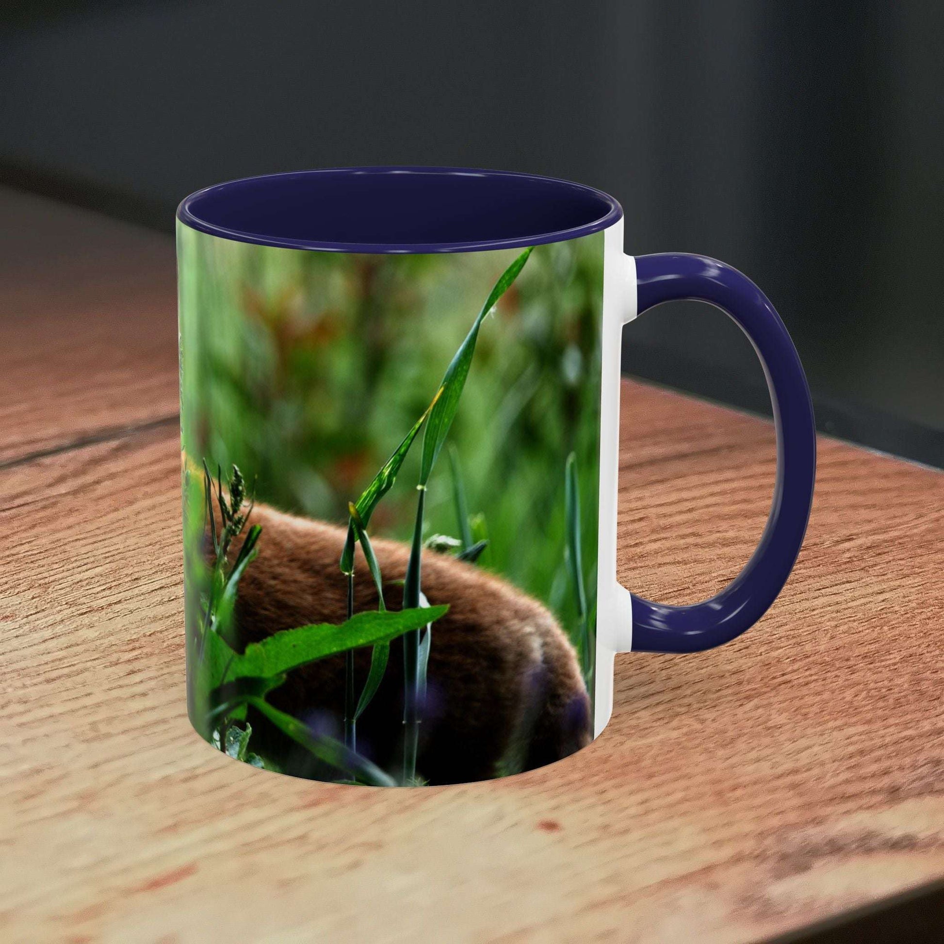 Fox-inspired accent coffee mug on wooden surface, featuring a nature-themed design and vibrant colors.