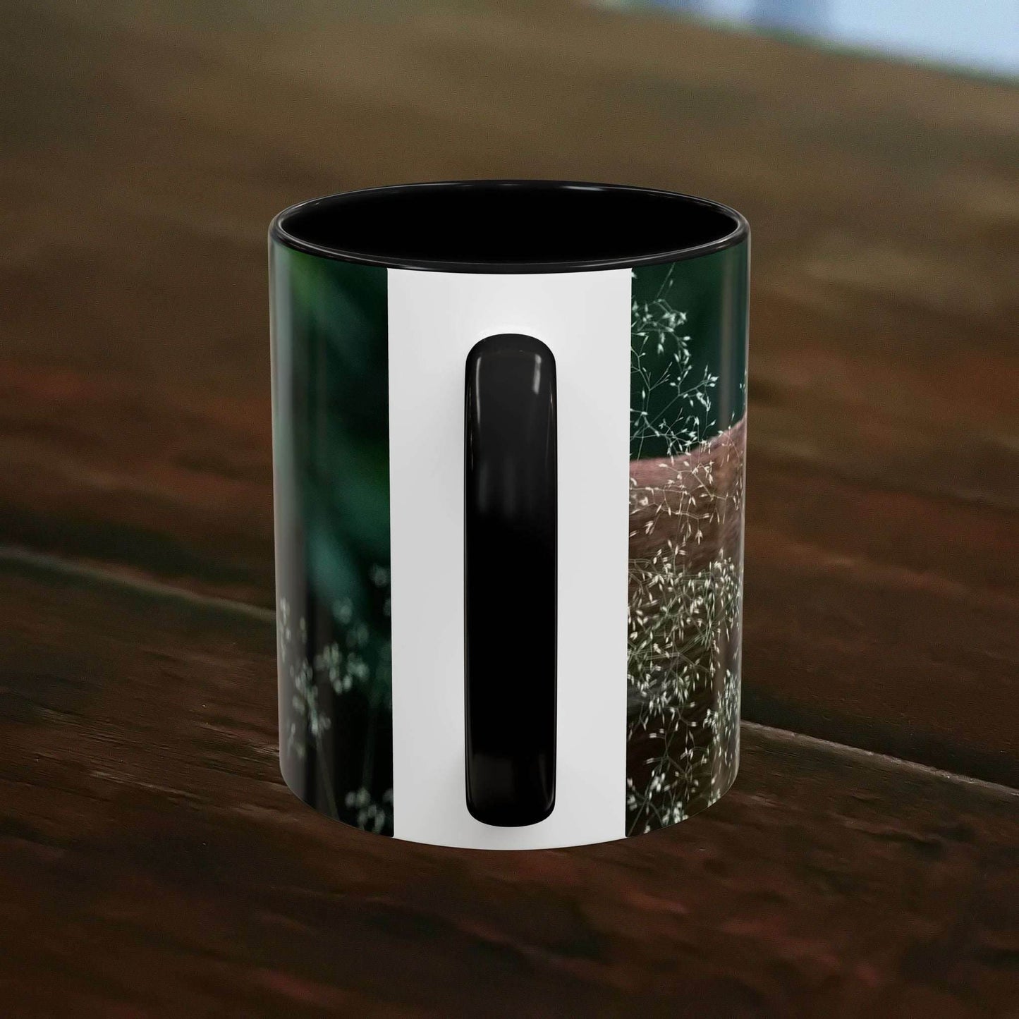 Nature-Inspired Deer Ceramic Mug - 11oz on a wooden table with floral accents.