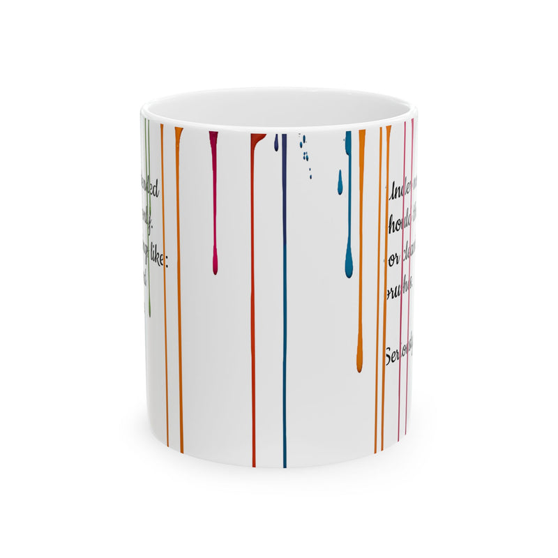 Glossy 11oz Paint Drips Mug, Ceramic Coffee Cup near a bright room window during a relaxing studio break.