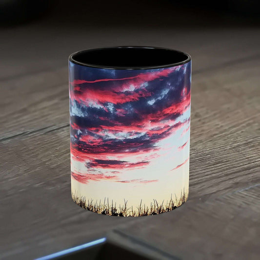 Sunset Accent Coffee Mug with vibrant colors and glossy finish on a wooden table.