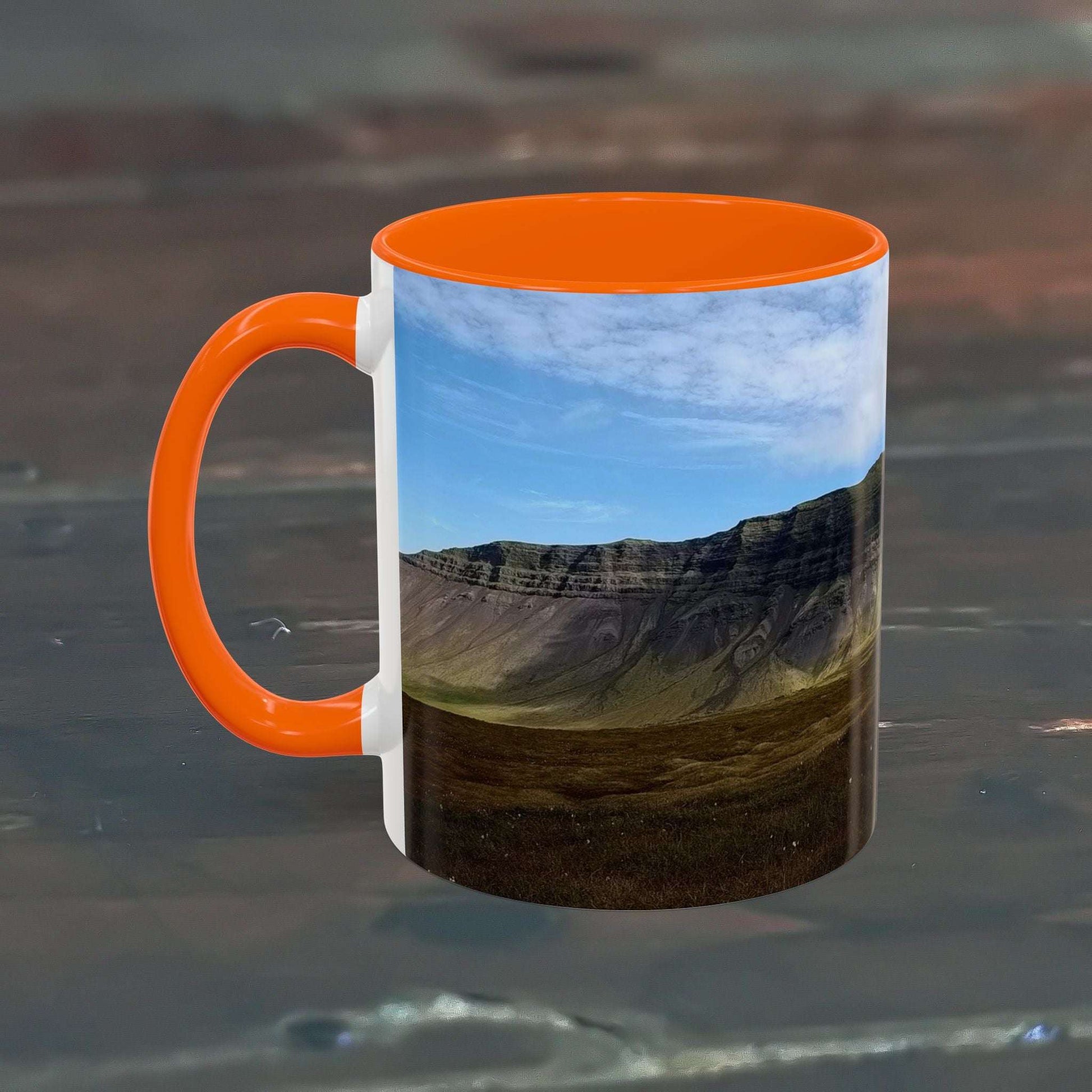Coffee mug featuring Iceland scenery with orange interior and handle, 11oz capacity.