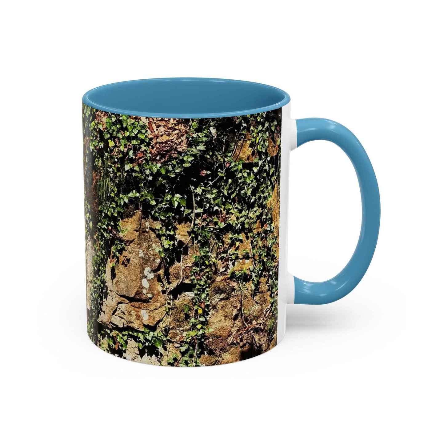 Premium 11oz Mug - Overgrown Rocks Adventure Coffee Mug in morning sun, featuring a light blue handle and light blue inside.