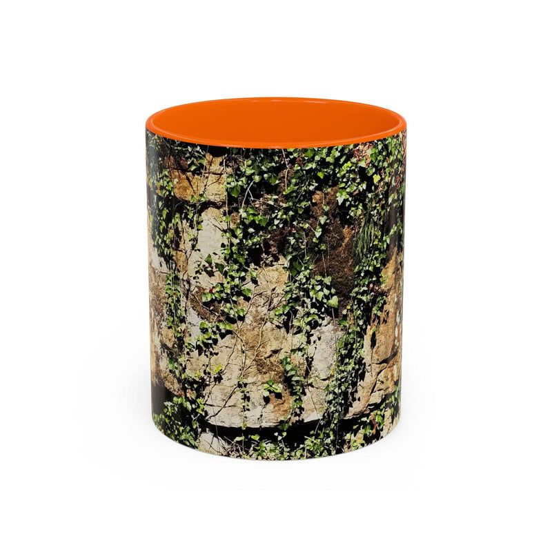 Adventurous 11oz Mug - Overgrown Rocks Adventure Coffee Mug showing the orange handle and orange inside near a bowl.