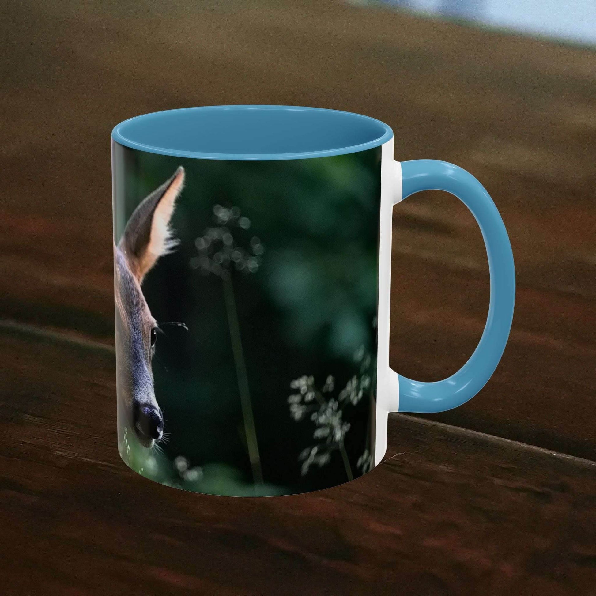 Nature-Inspired Deer Ceramic Mug - 11oz with elegant deer and floral design on a wooden table.