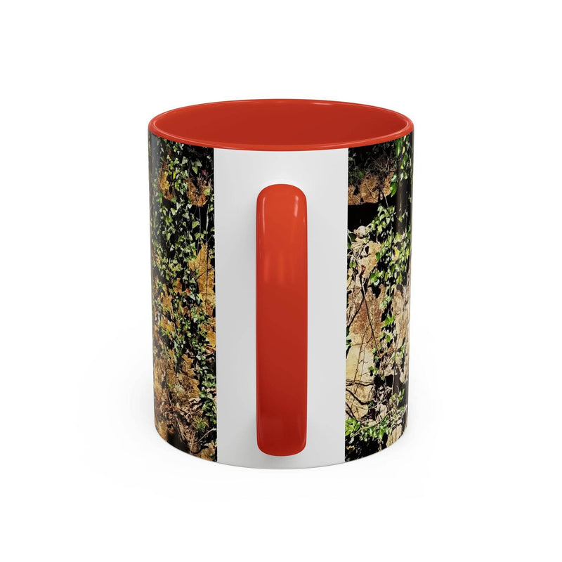 Outdoorsy 11oz Mug - Overgrown Rocks Adventure Coffee Mug on a stand, showcasing its red handle and red inside.