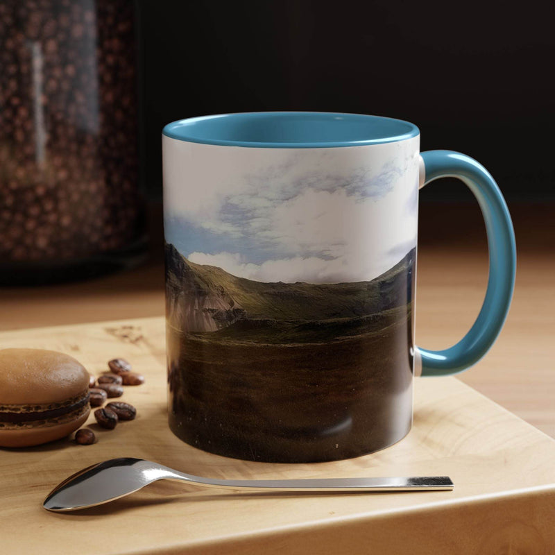 Nordic design 11oz Coffee Mug - Iceland Scenery by a window, showing its light blue handle and light blue inside.