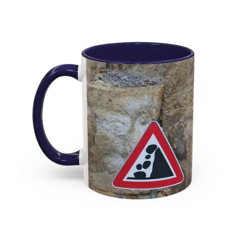 Adventurous 11oz Rocky Mug, Mountain Lovers, Danger of Falling Rocks with a navy handle and navy inside on a counter.
